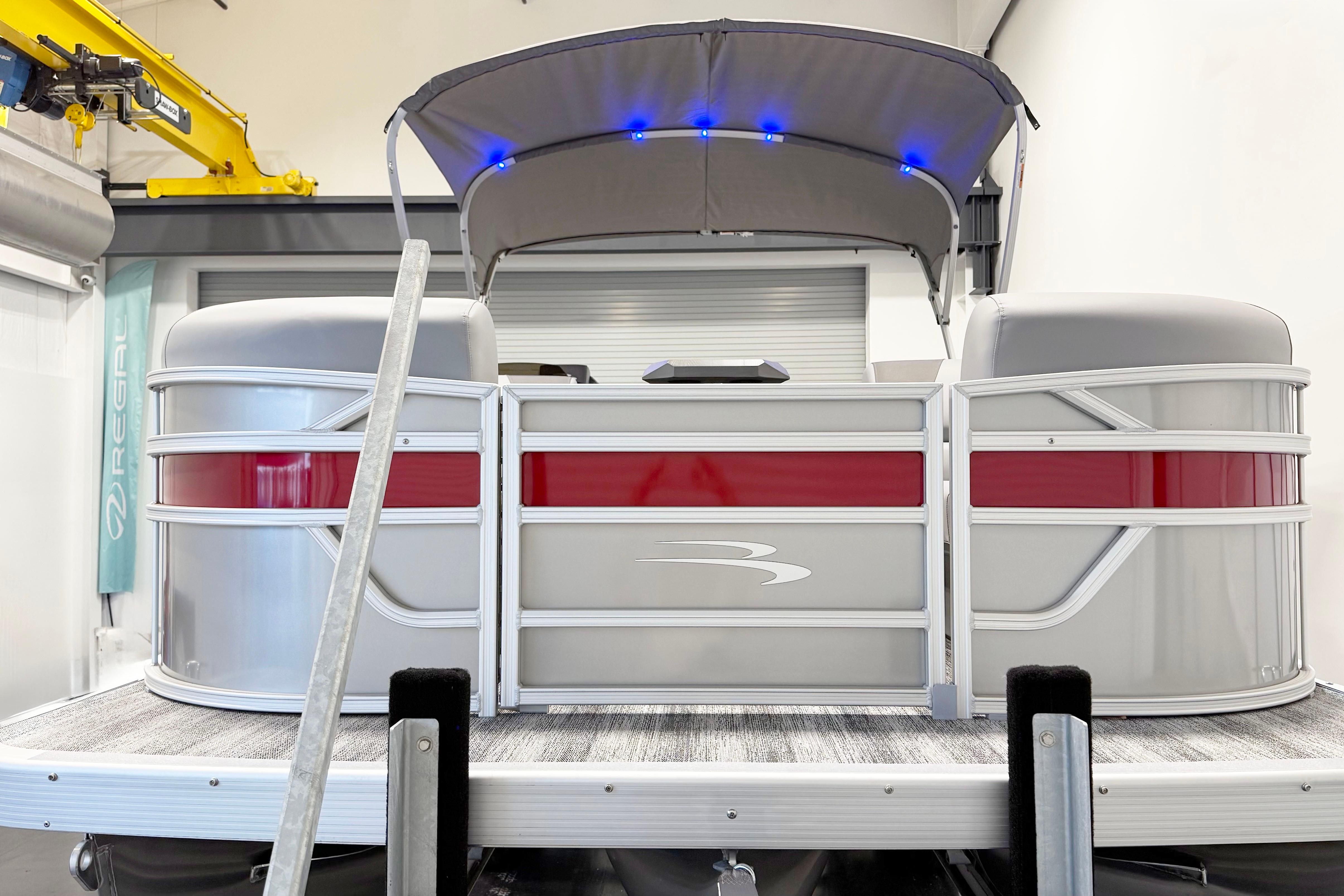 2025 Bennington 21S Cruise pontoon boat with canopy and LED lights in a showroom.