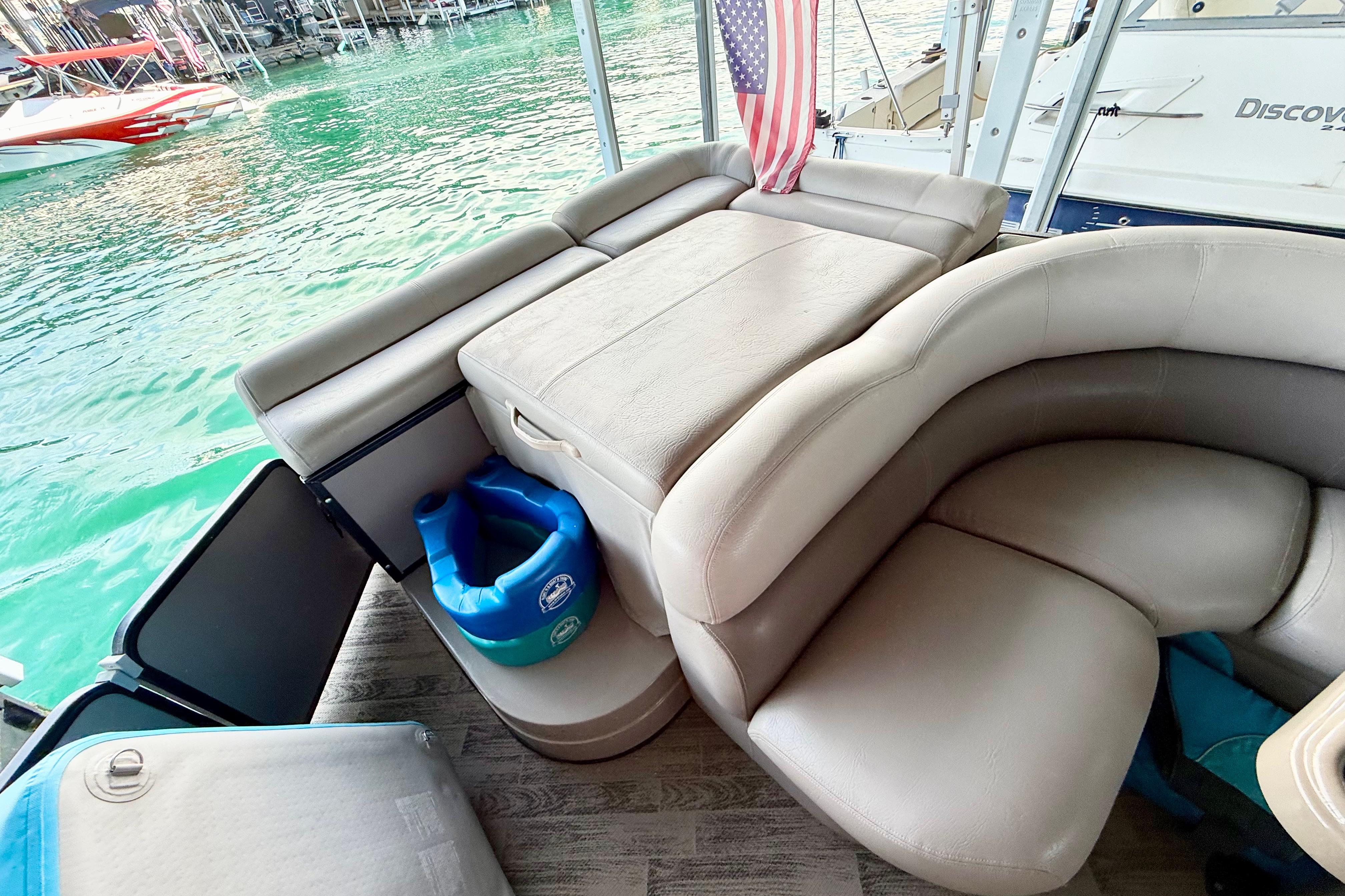 Interior of 2011 Premier 275 Grand Majestic PTX pontoon boat with plush seating and lake view.