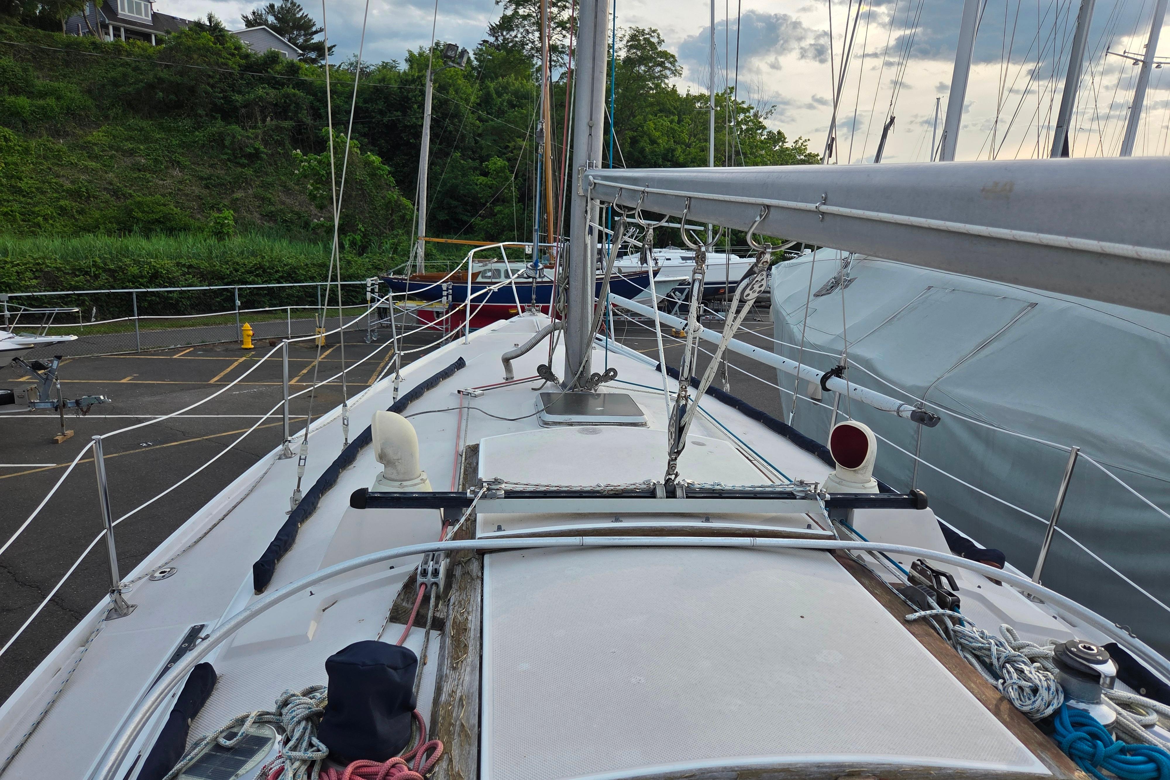 Sailboat deck view of a 1986 Catalina 355, docked with lush greenery in the background.