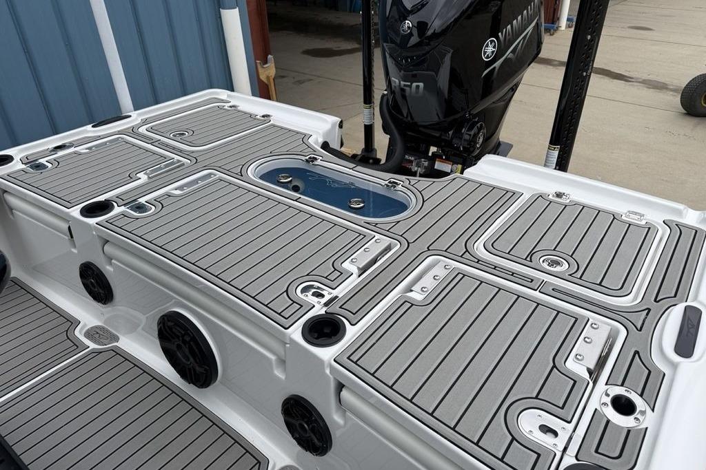 2026 Tidewater 2500 Carolina Bay boat deck with Yamaha engine, featuring sleek design and storage compartments.