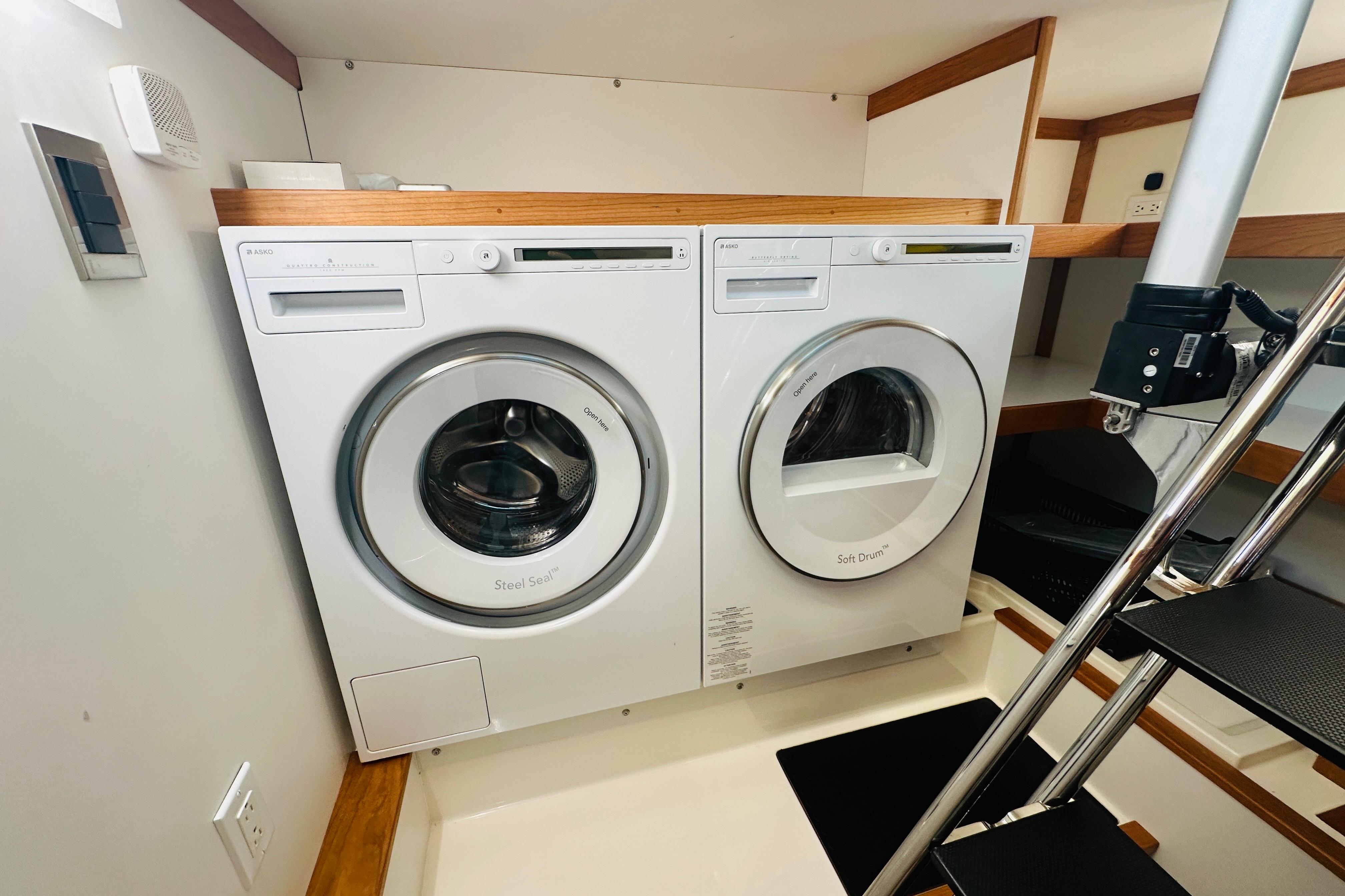 Laundry area inside 2025 Sabre 48 Salon Express yacht, featuring modern washer and dryer.