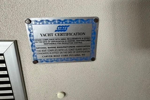 Yacht certification plaque on 1989 Carver 32 Aft Cabin Motor Yacht, NMMA compliance.