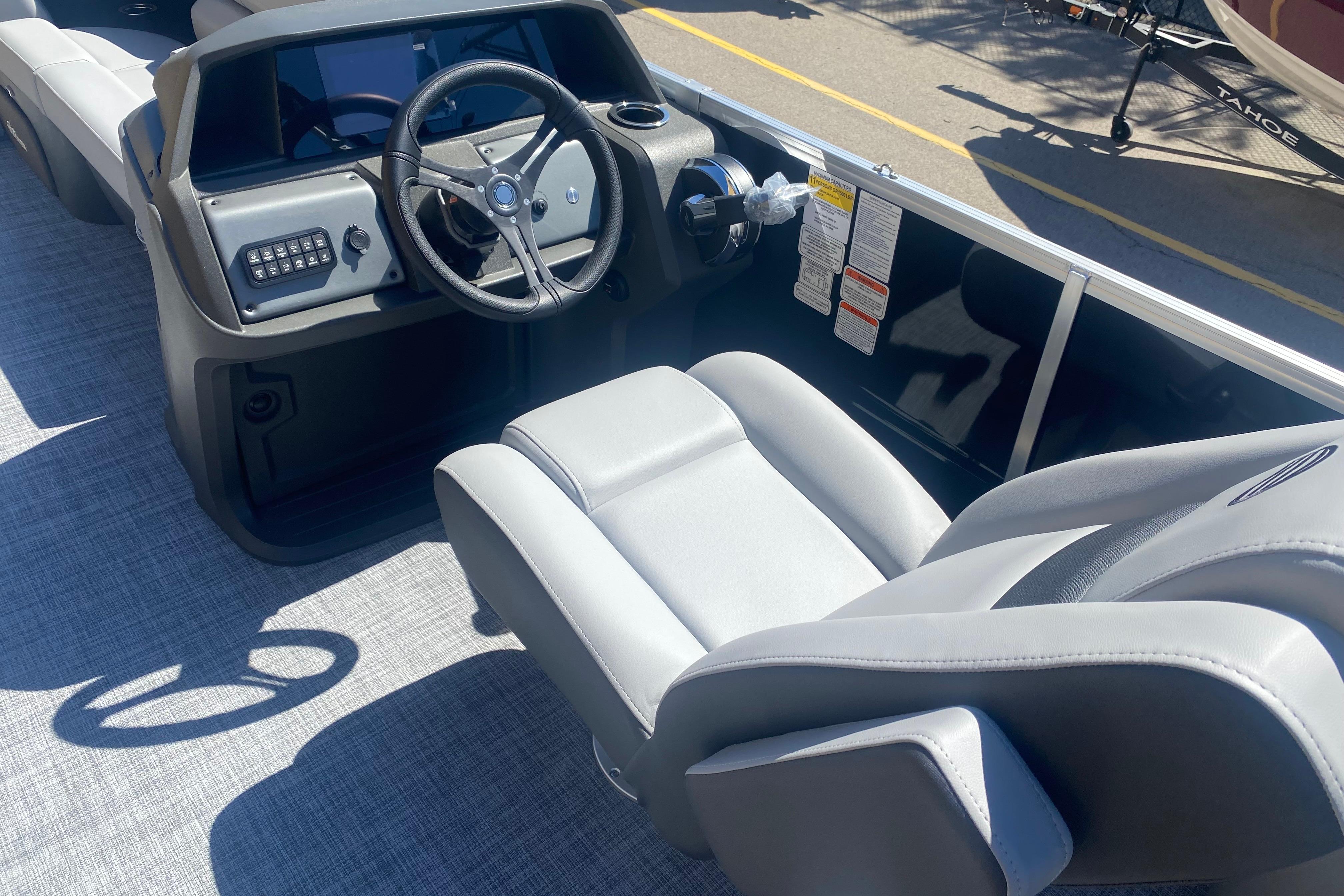 Interior view of 2026 Sun Tracker Party Barge 22 RF DLX with steering wheel and seating.