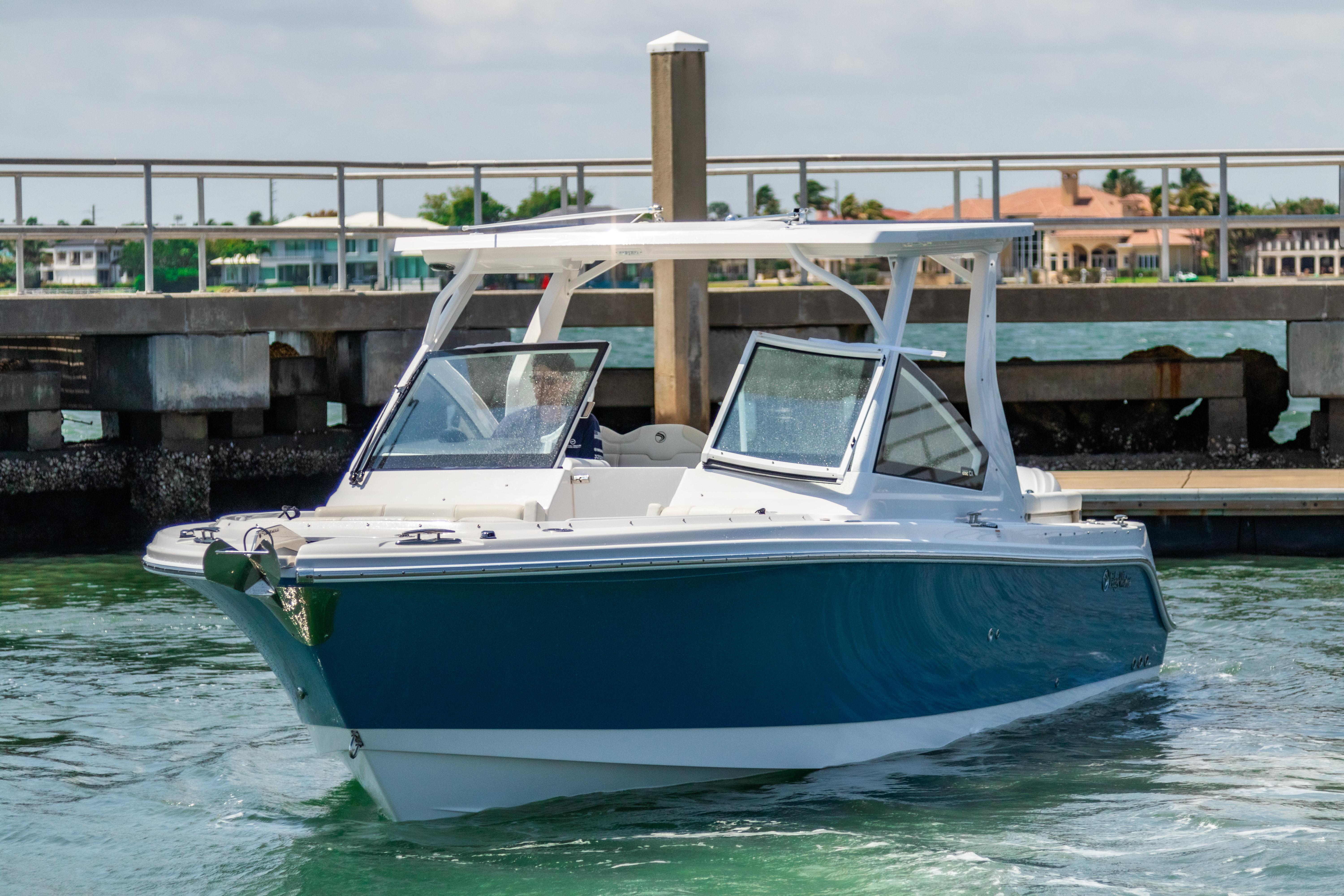 2025 Edgewater 262 CX boat docked in marina, blue and white design.