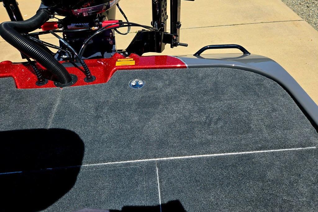 Rear deck of 2026 Skeeter ZXE20 boat with carpeted surface and motor components.