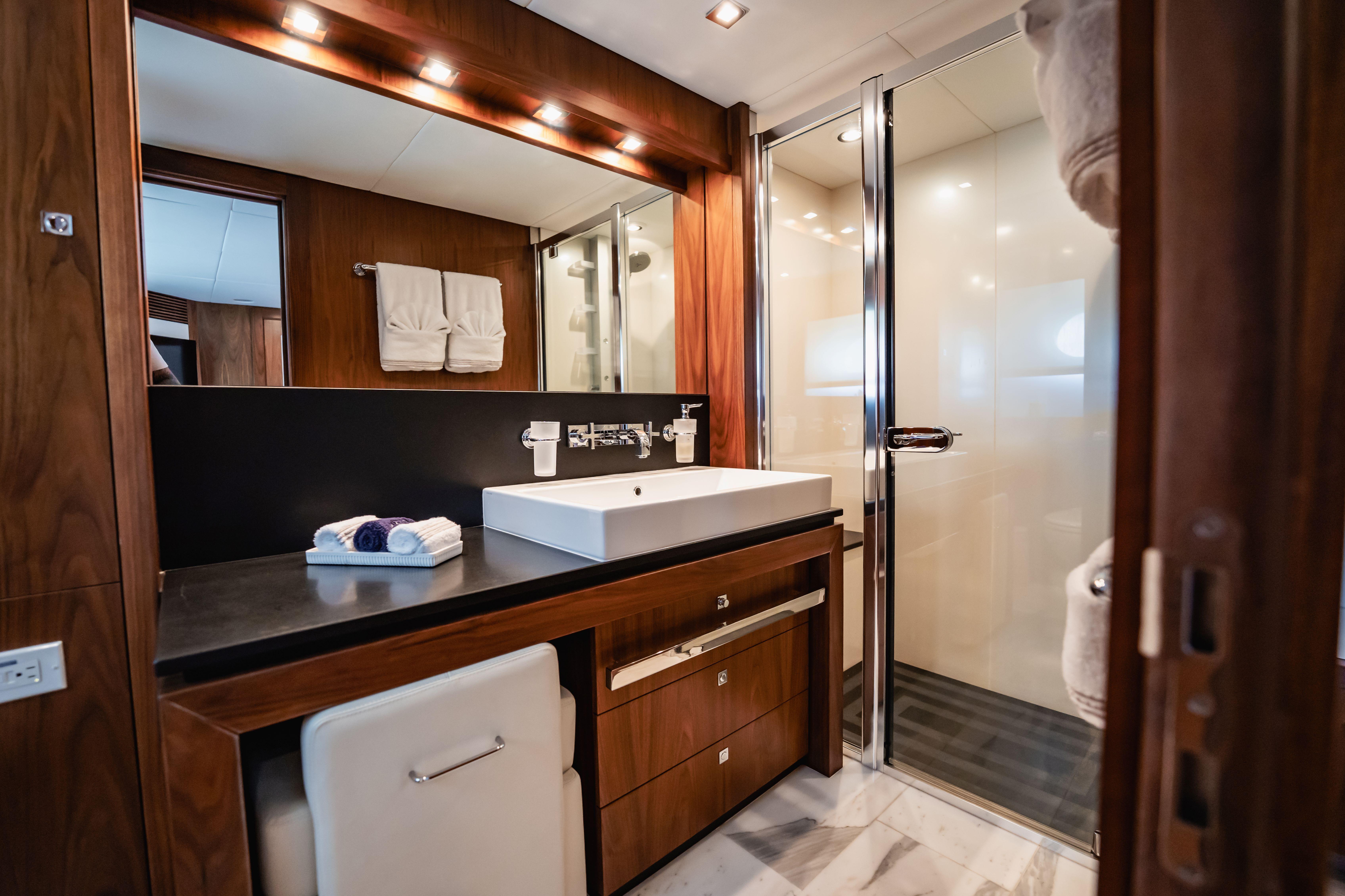Luxurious bathroom on 2011 Sunseeker 34 Metre Yacht with modern fixtures and elegant wood finishes.