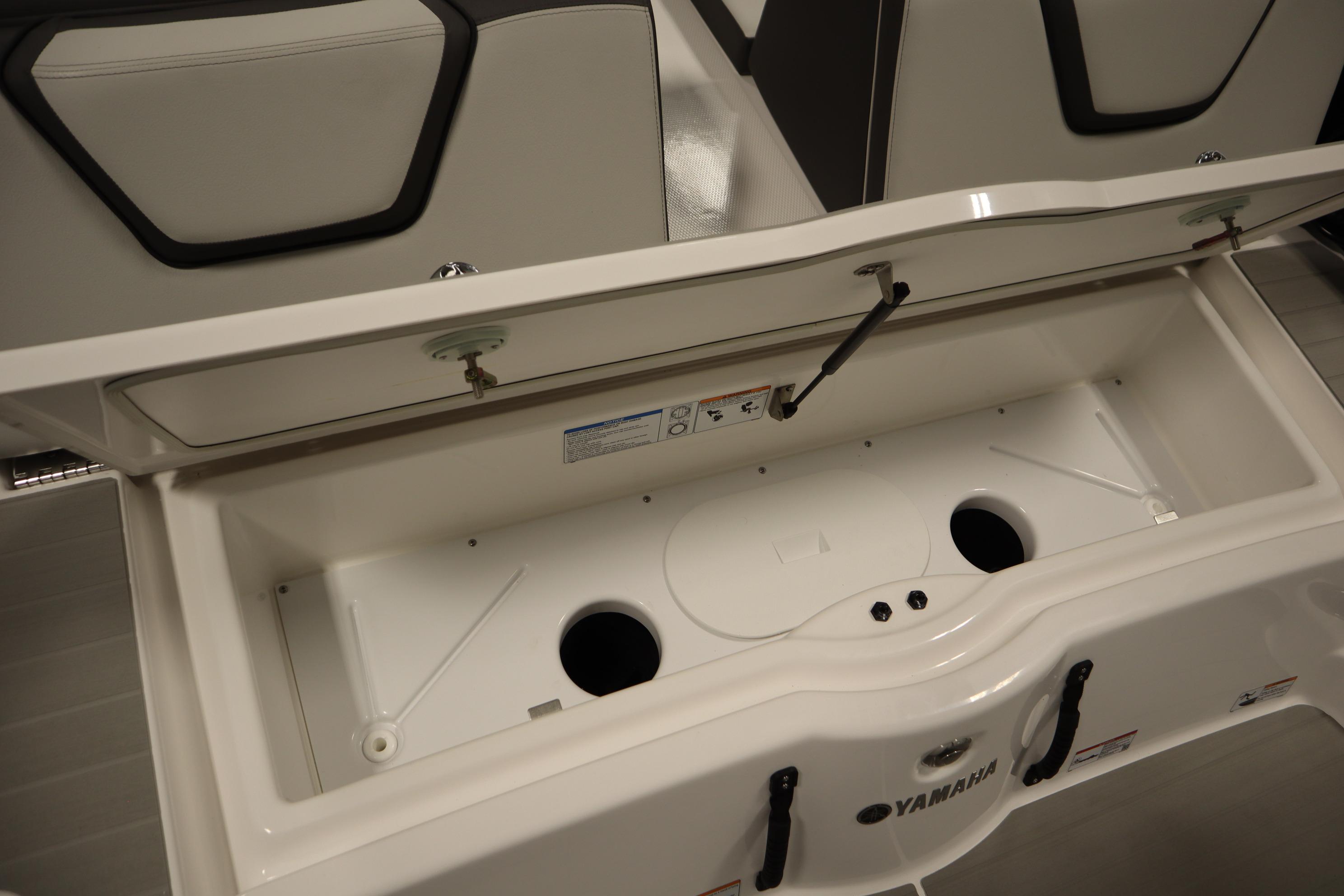 Open storage compartment of 2026 Yamaha Boats AR250, showcasing interior design and functionality.