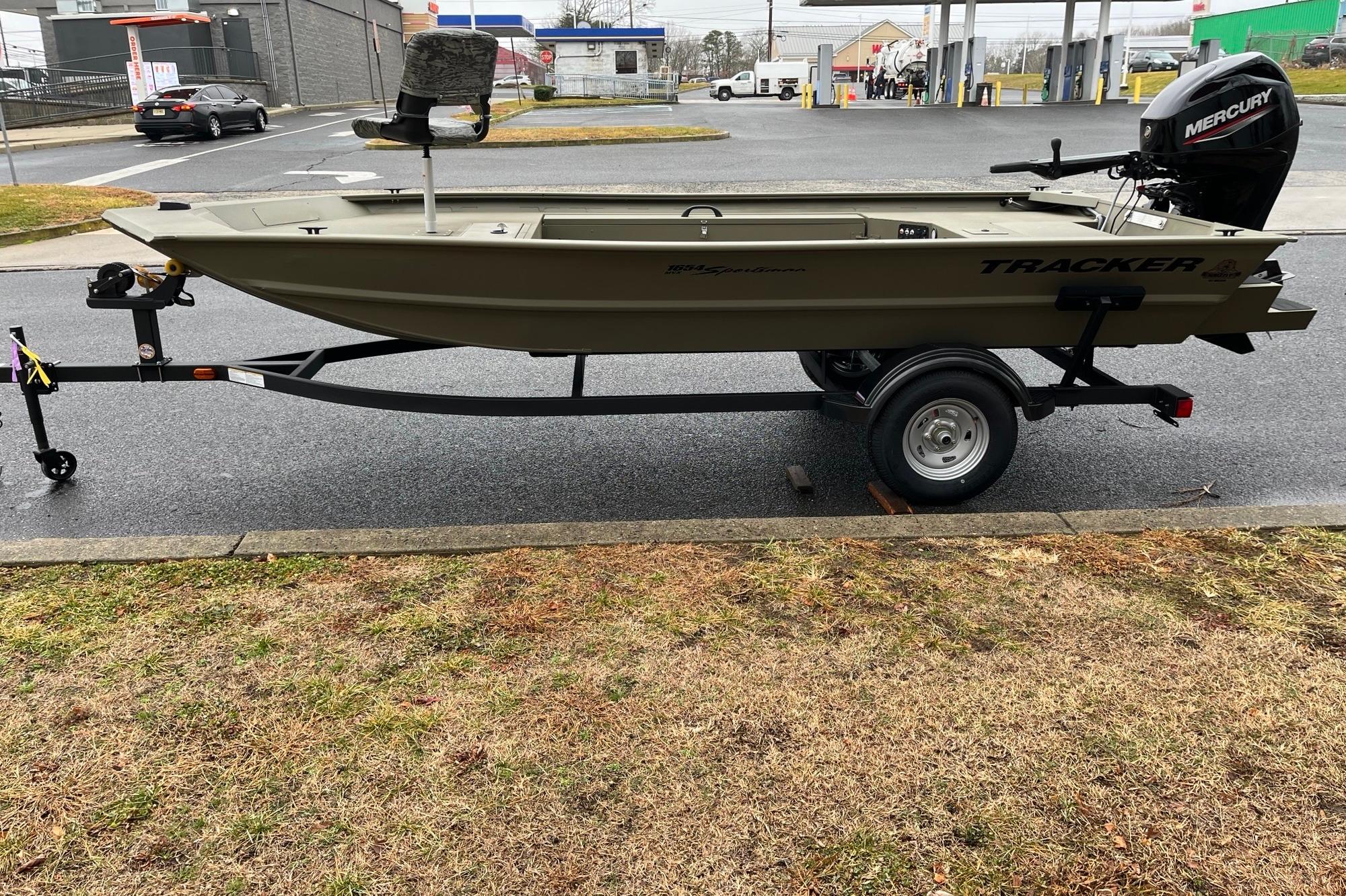 2026 Tracker Grizzly 1654 T Sportsman boat on trailer, parked outdoors.