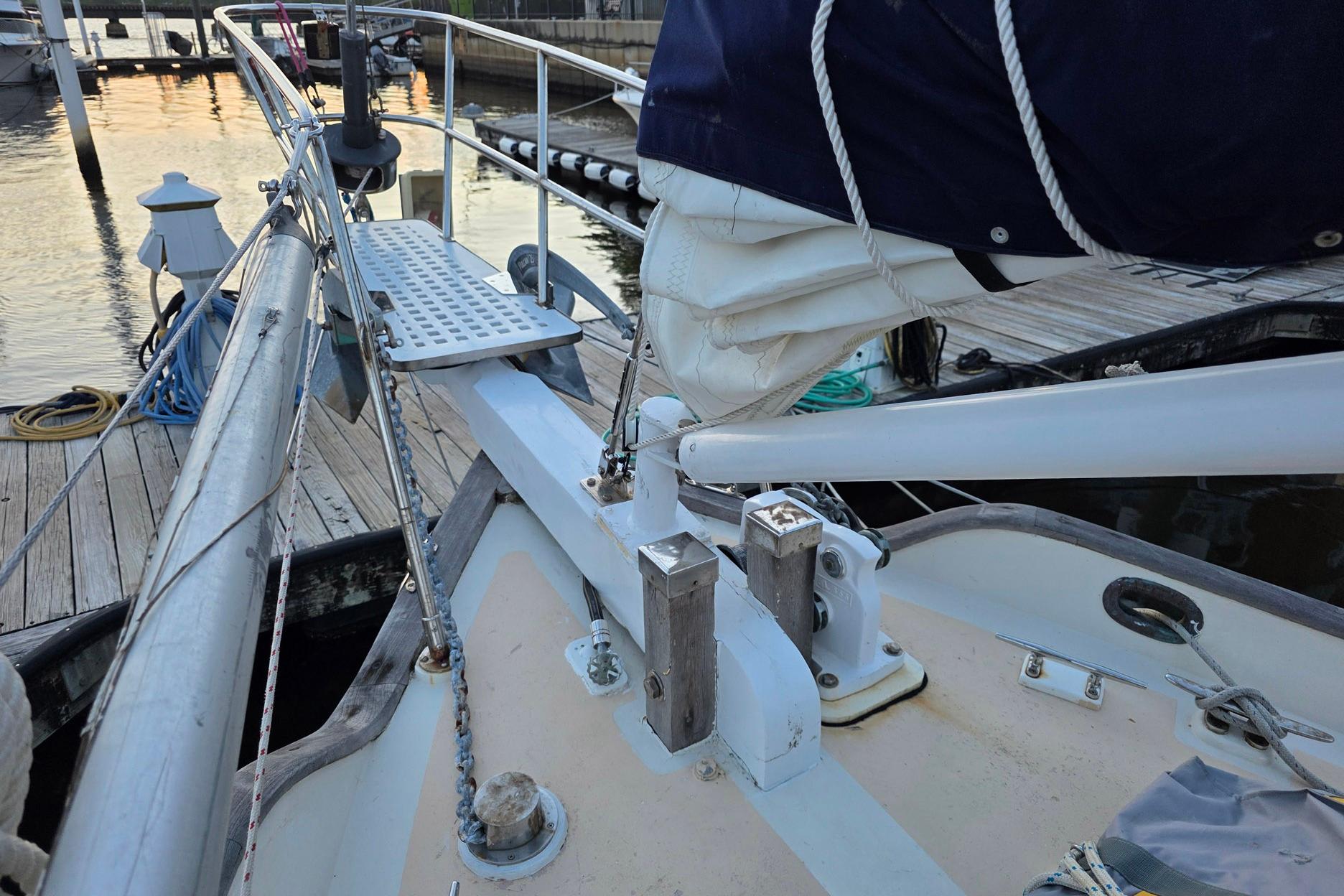 1982 Tayana 37 sailboat deck with rigging and dock in background.