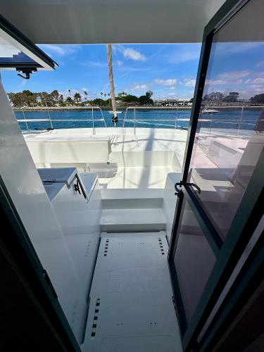2021 Bali 4.8 yacht interior with ocean view through open door.