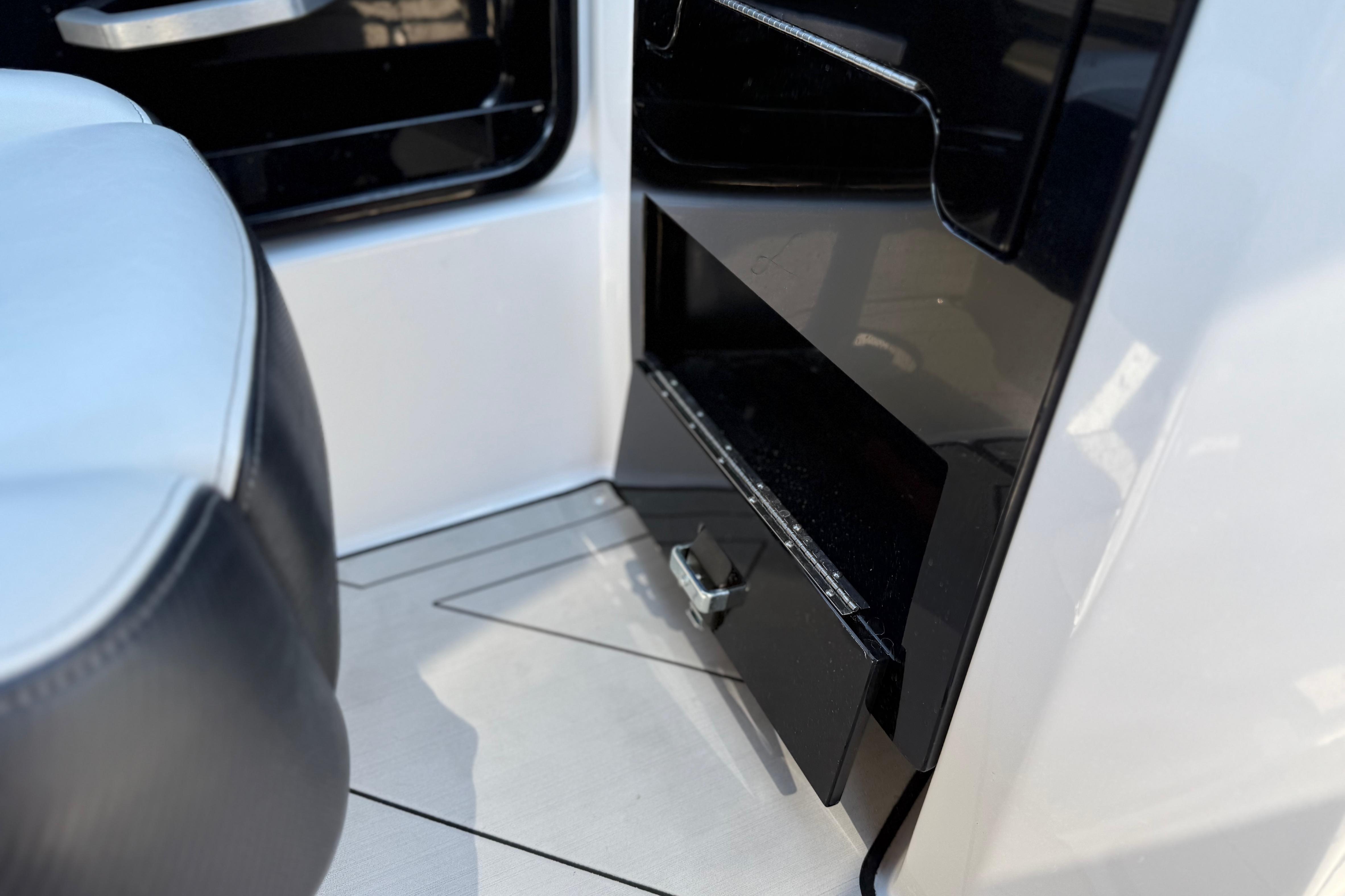 Interior detail of 2022 Yamaha Boats 212XE, featuring sleek black and white design elements.