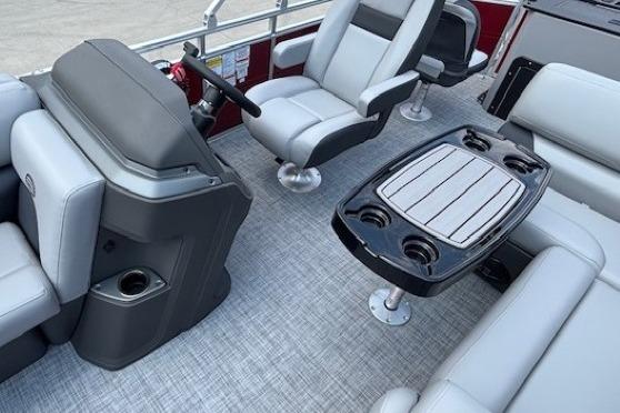 2026 Sun Tracker SportFish 20 DLX interior with seating and table, showcasing modern design.