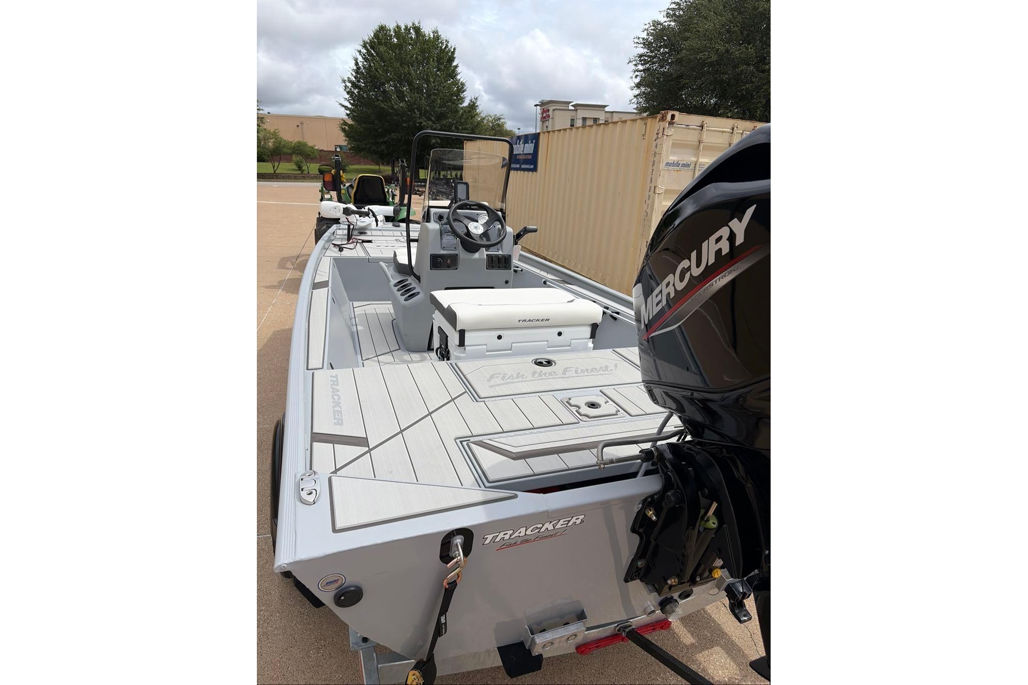 2026 Tracker Bass Tracker Classic CC boat with Mercury engine, parked outdoors.