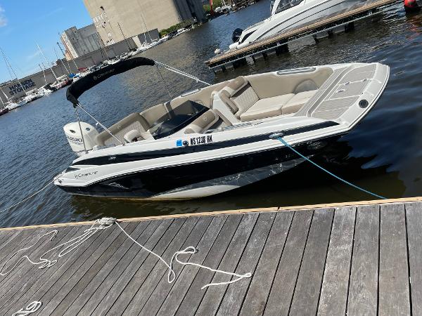 2020 Crownline E 205 XS boat docked at marina, sunny day.