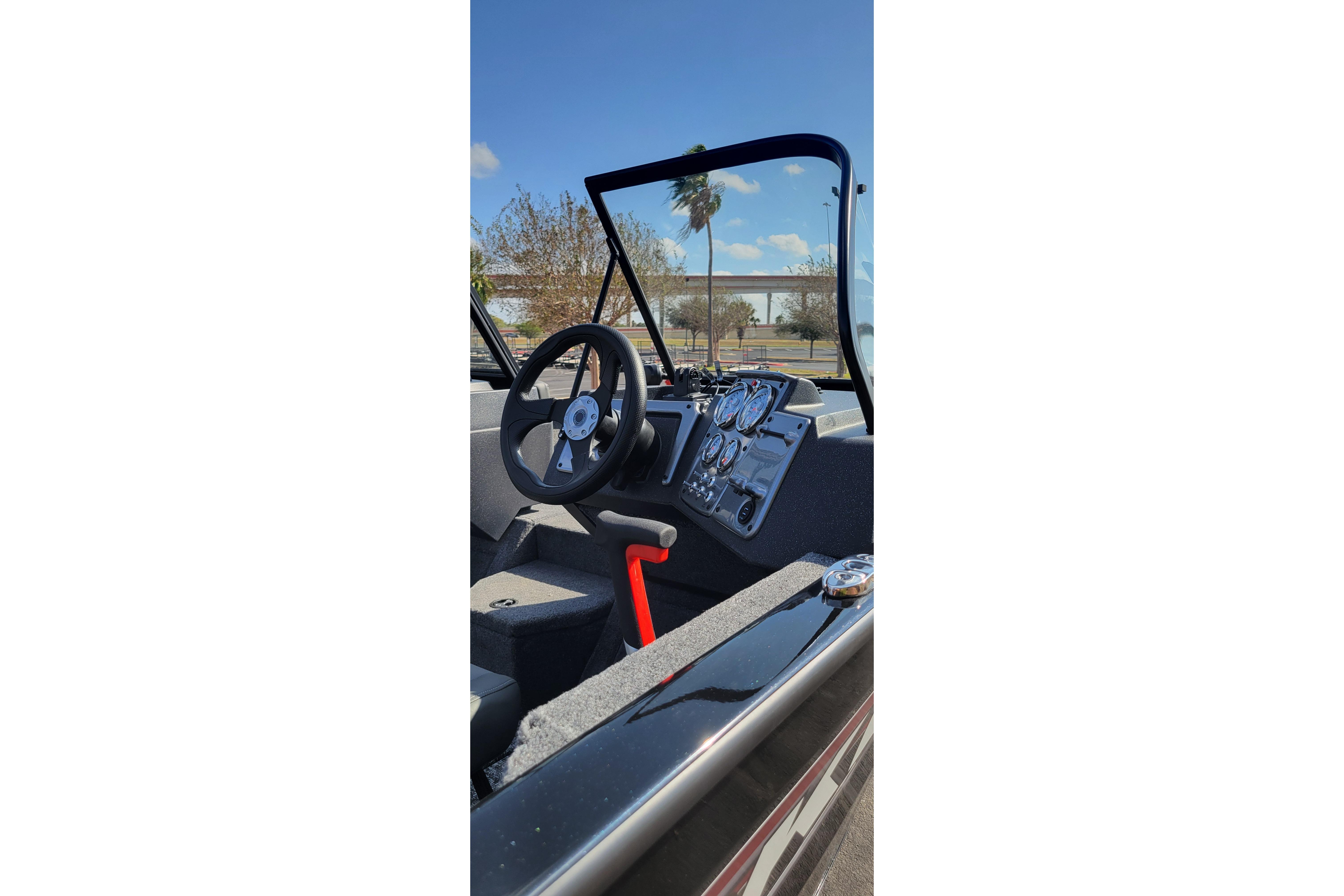 Interior view of 2026 Tracker Pro Guide V-175 Combo boat, featuring steering wheel and dashboard controls.