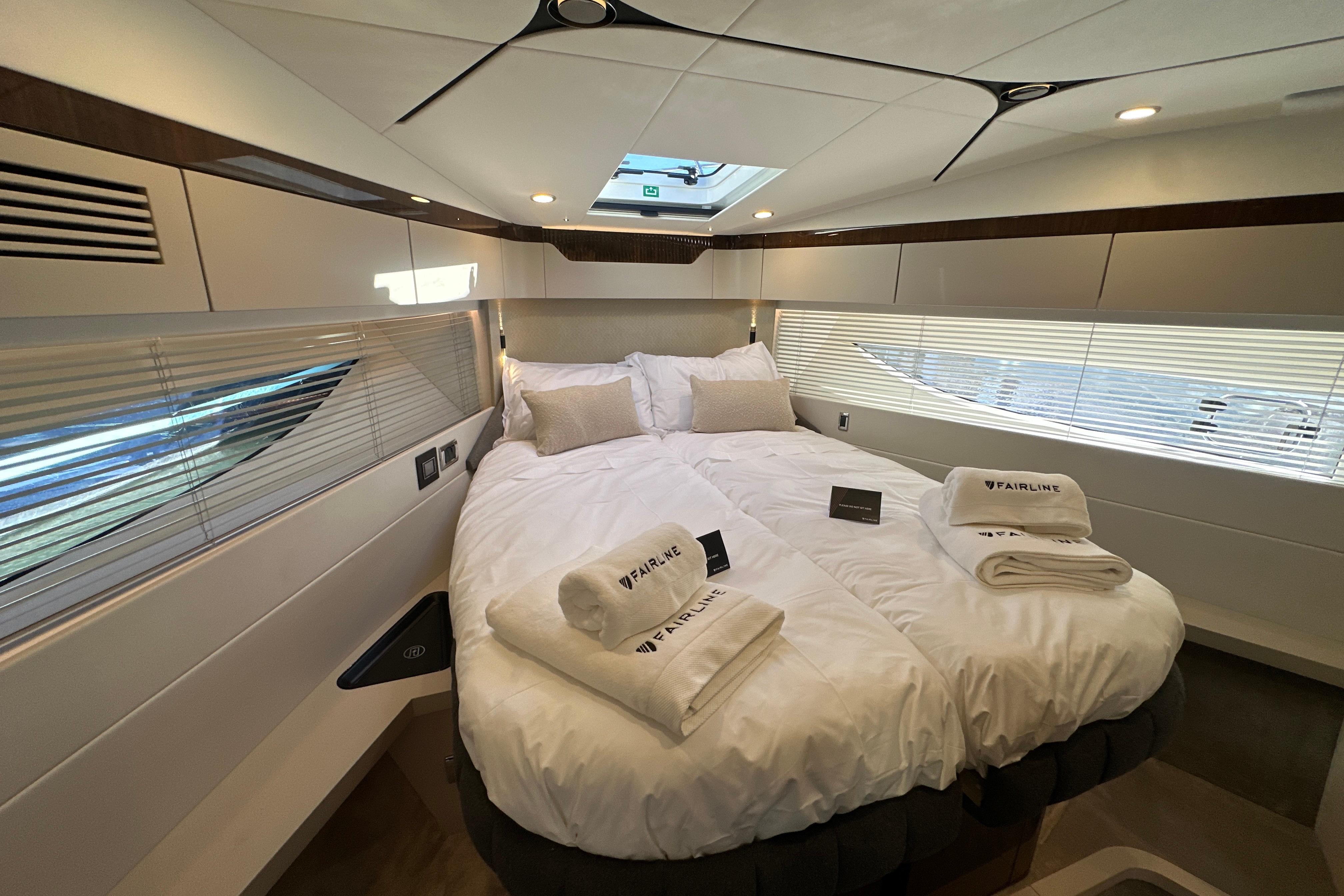 Luxurious cabin interior of 2026 Fairline Targa 47 GT yacht with plush bedding.