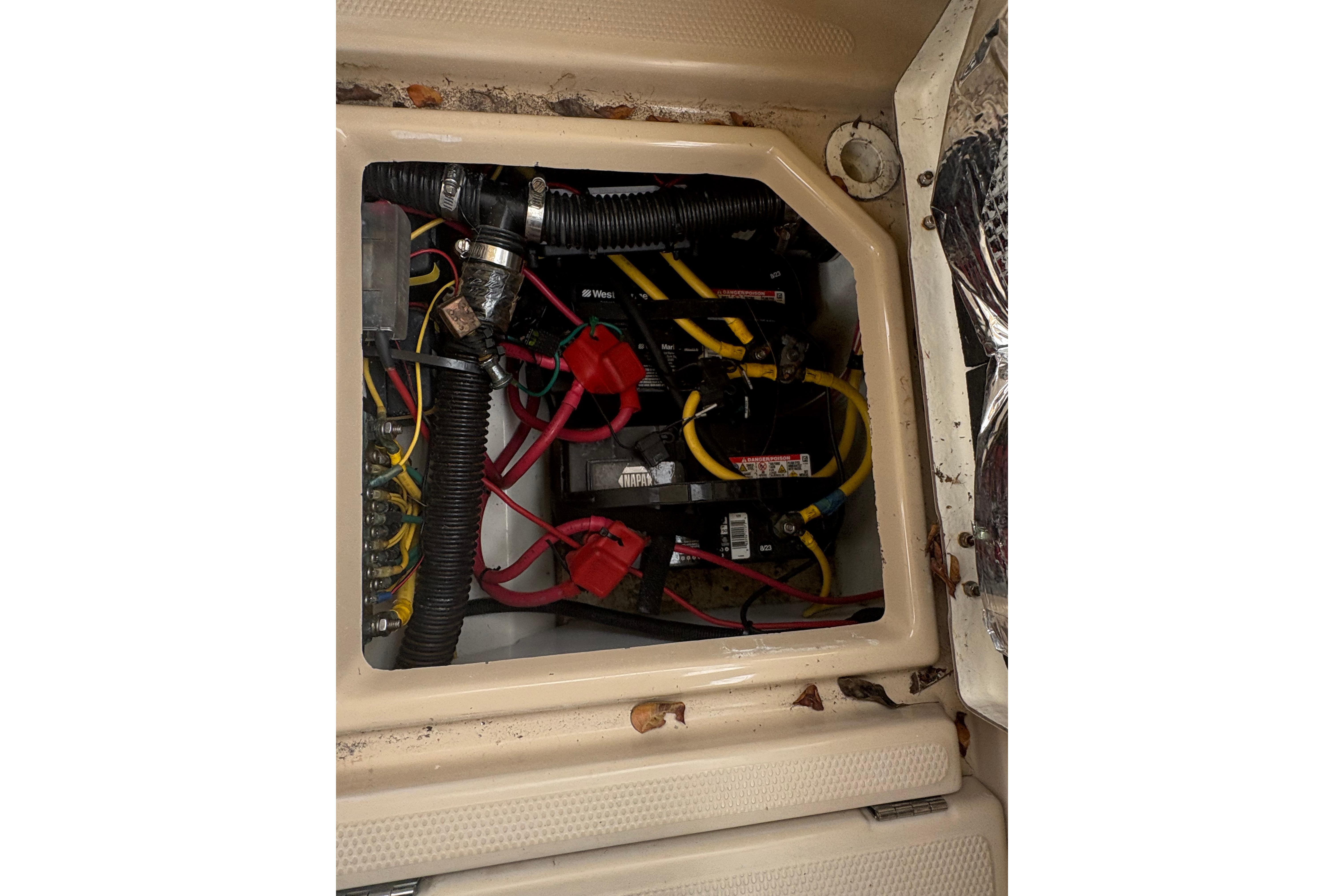 Electrical compartment of a 2012 Cutwater C-26 boat with visible wiring and components.