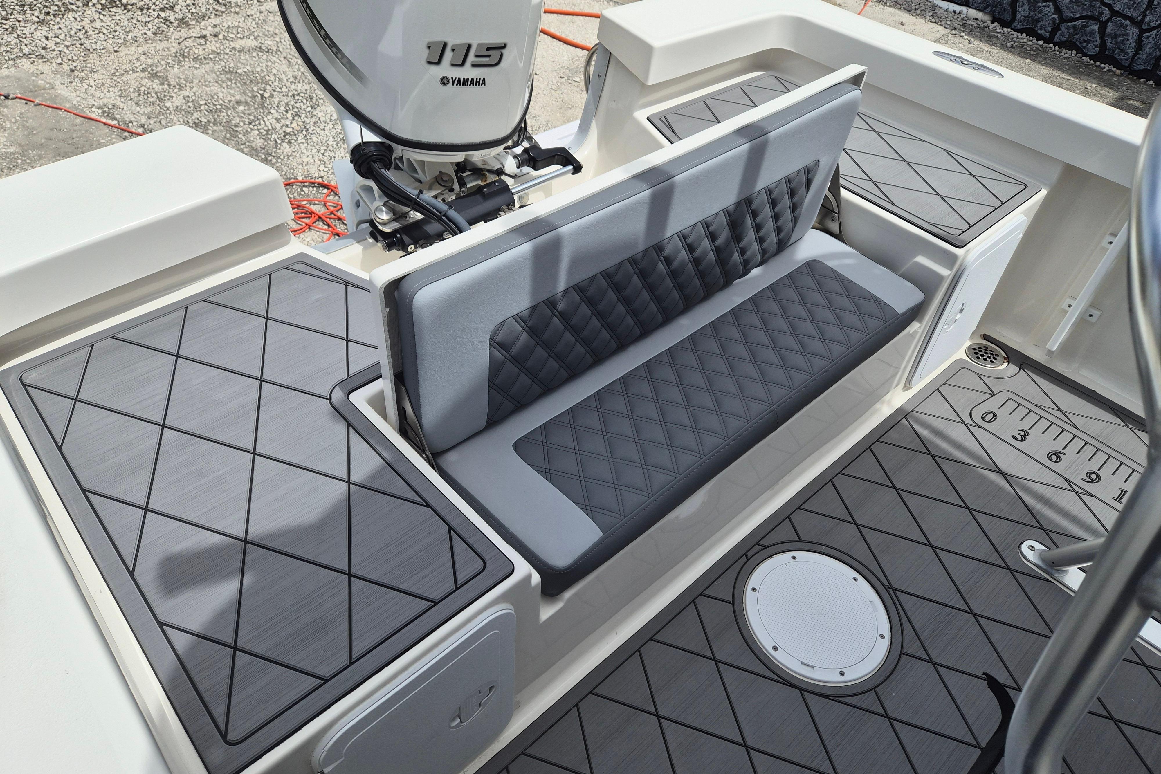 Interior of 2026 Defiance Catalina 190 boat with cushioned seating and Yamaha 115 engine.