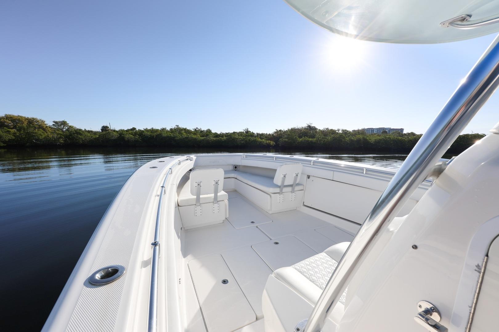 2016 Invincible 39 Open Fisherman boat on calm water under clear sky.