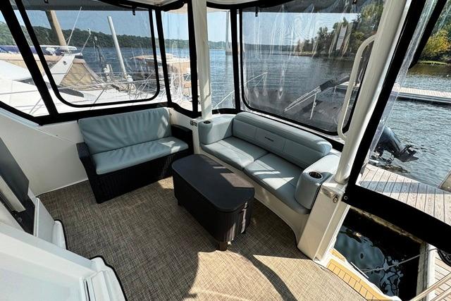 2004 Silverton 35 MY Aft Cabin Motoryacht interior with seating, docked by a scenic lake.