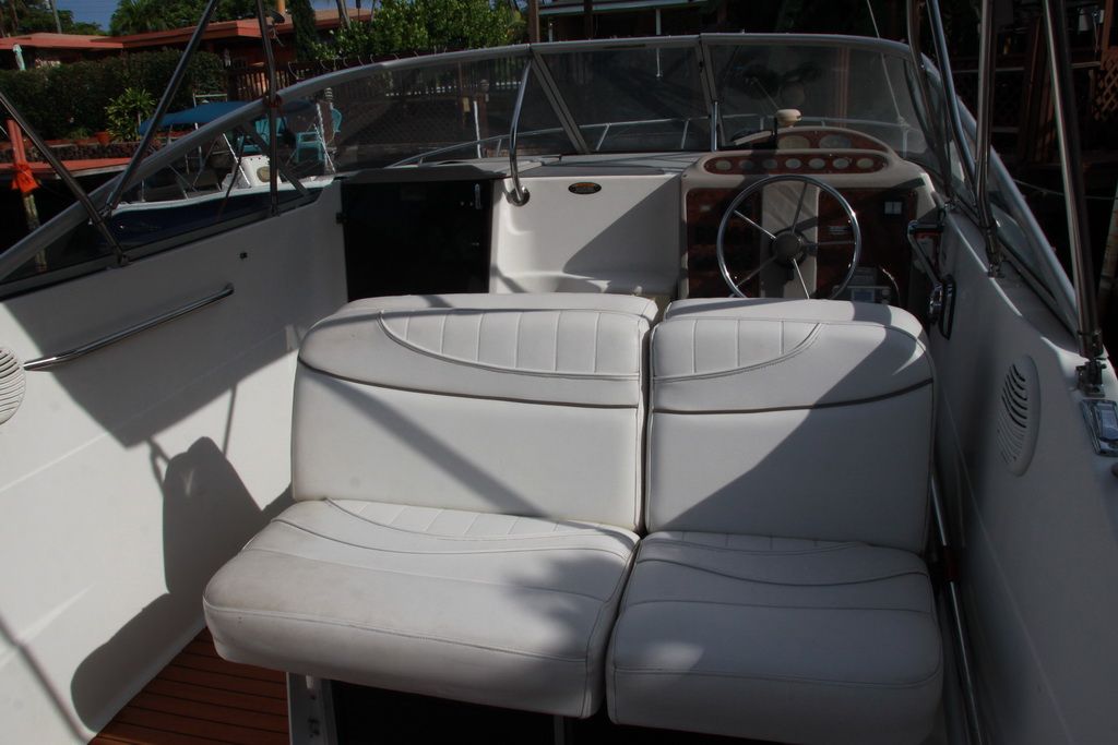 Interior of a 1999 Maxum 2400 Mercruiser boat with white seating.
