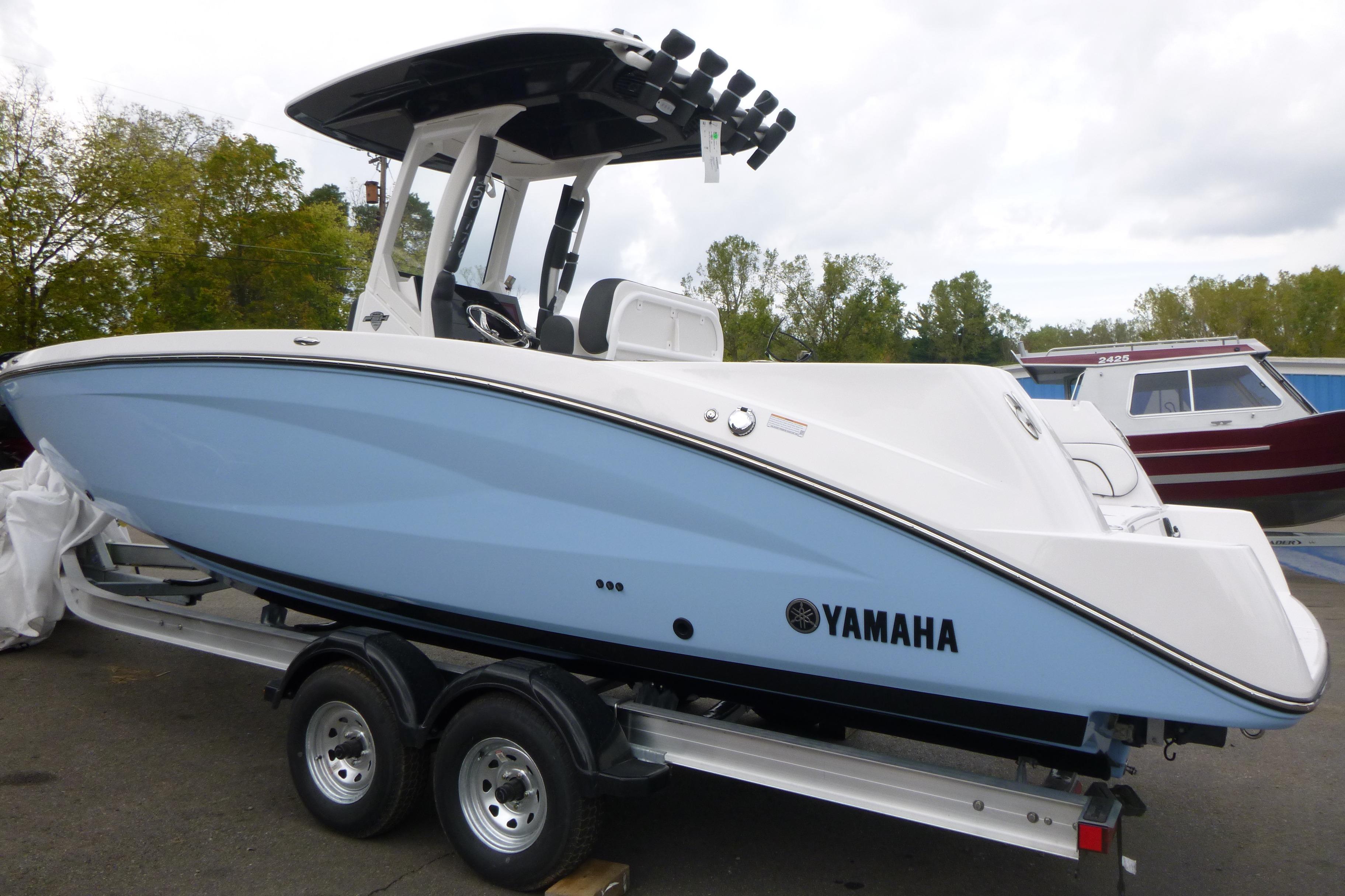 2026 Yamaha Boats 255 FSH Sport H on trailer, sleek design, light blue hull.