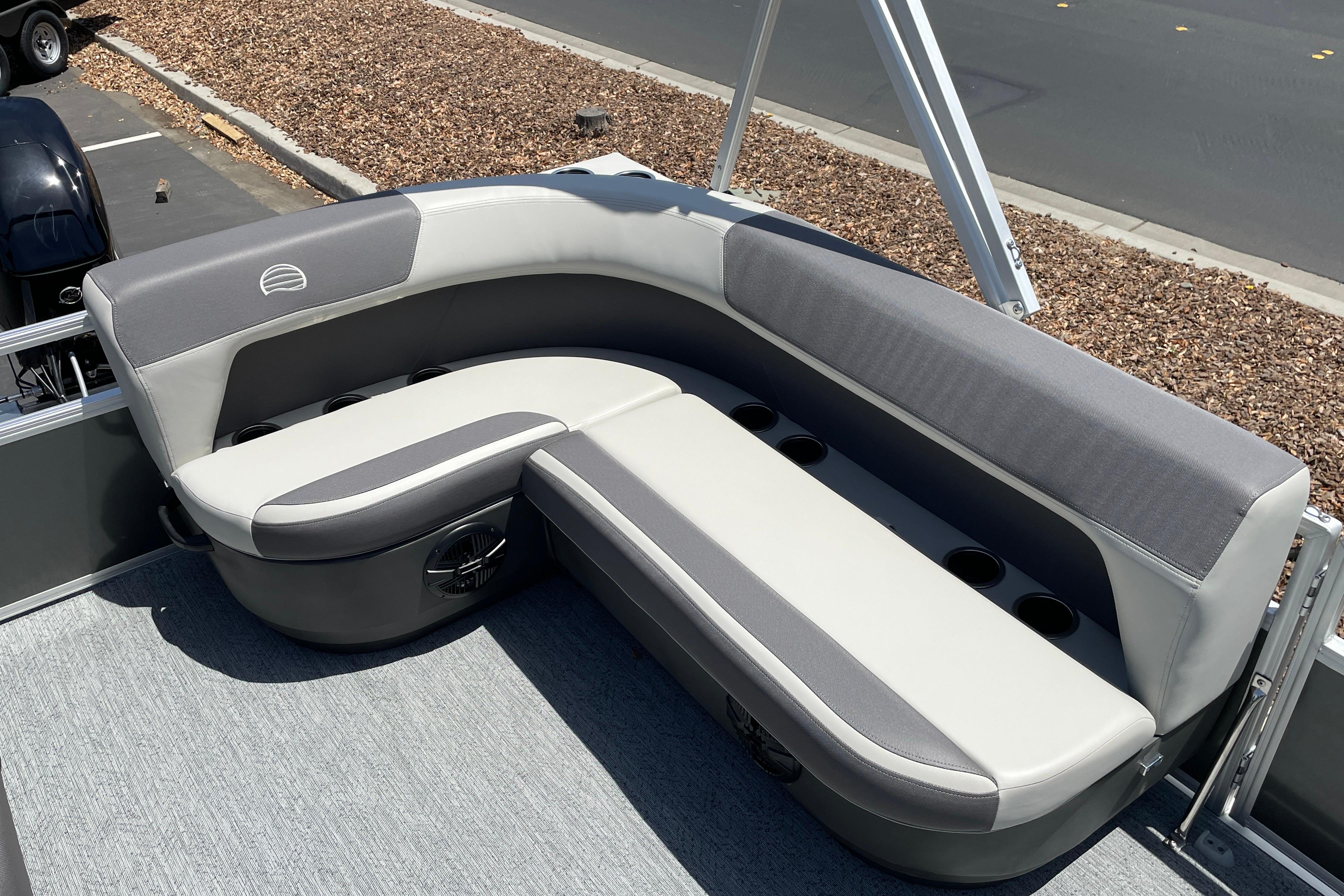2026 Sun Tracker Bass Buggy 16 XL Select pontoon boat seating area with cup holders.