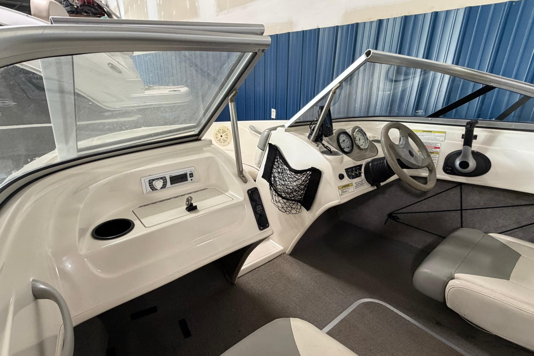 2012 Bayliner 175 Bowrider interior with steering wheel, dashboard, and seating.
