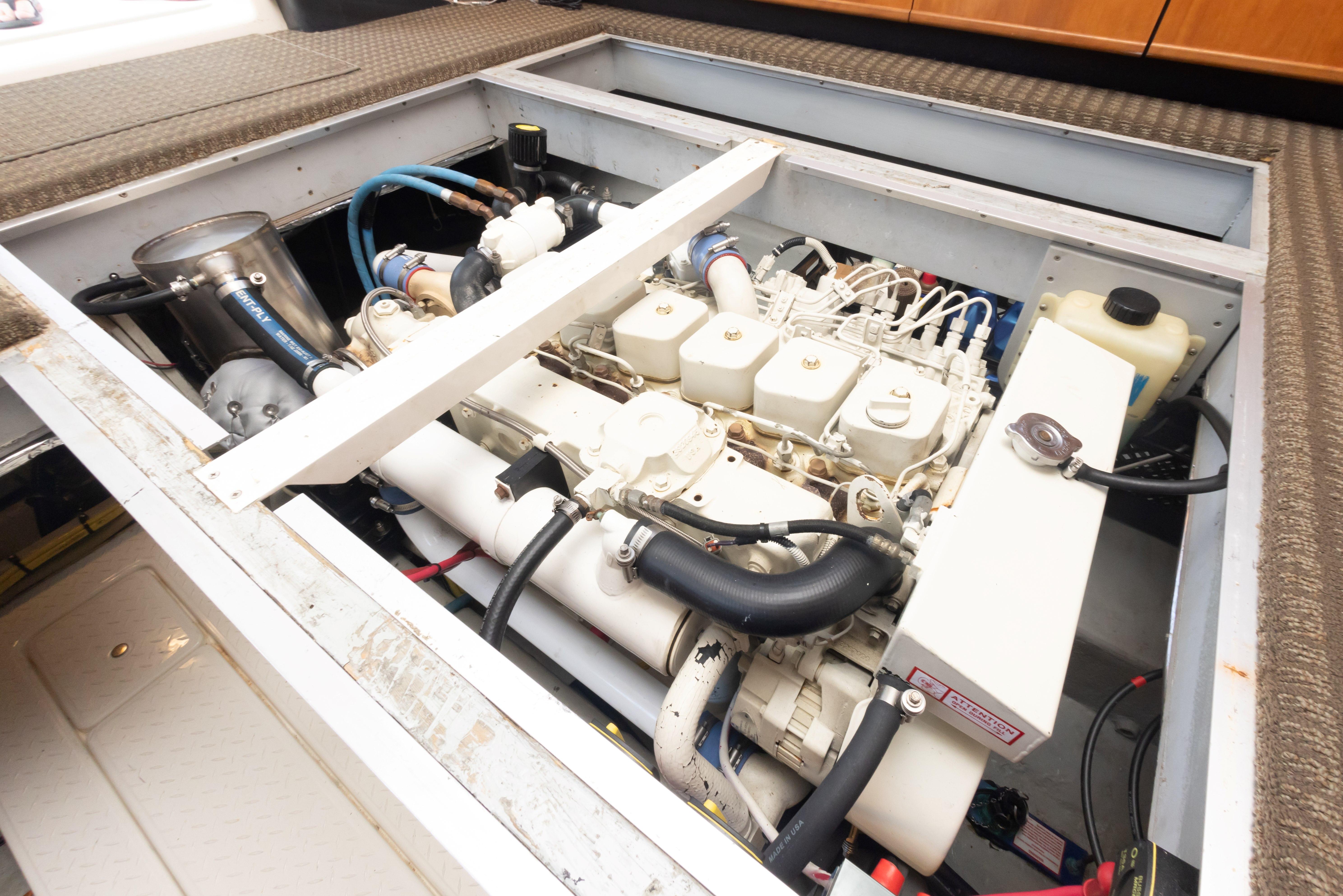 Engine compartment of a 2004 Meridian 490 Pilothouse yacht, showcasing mechanical components.