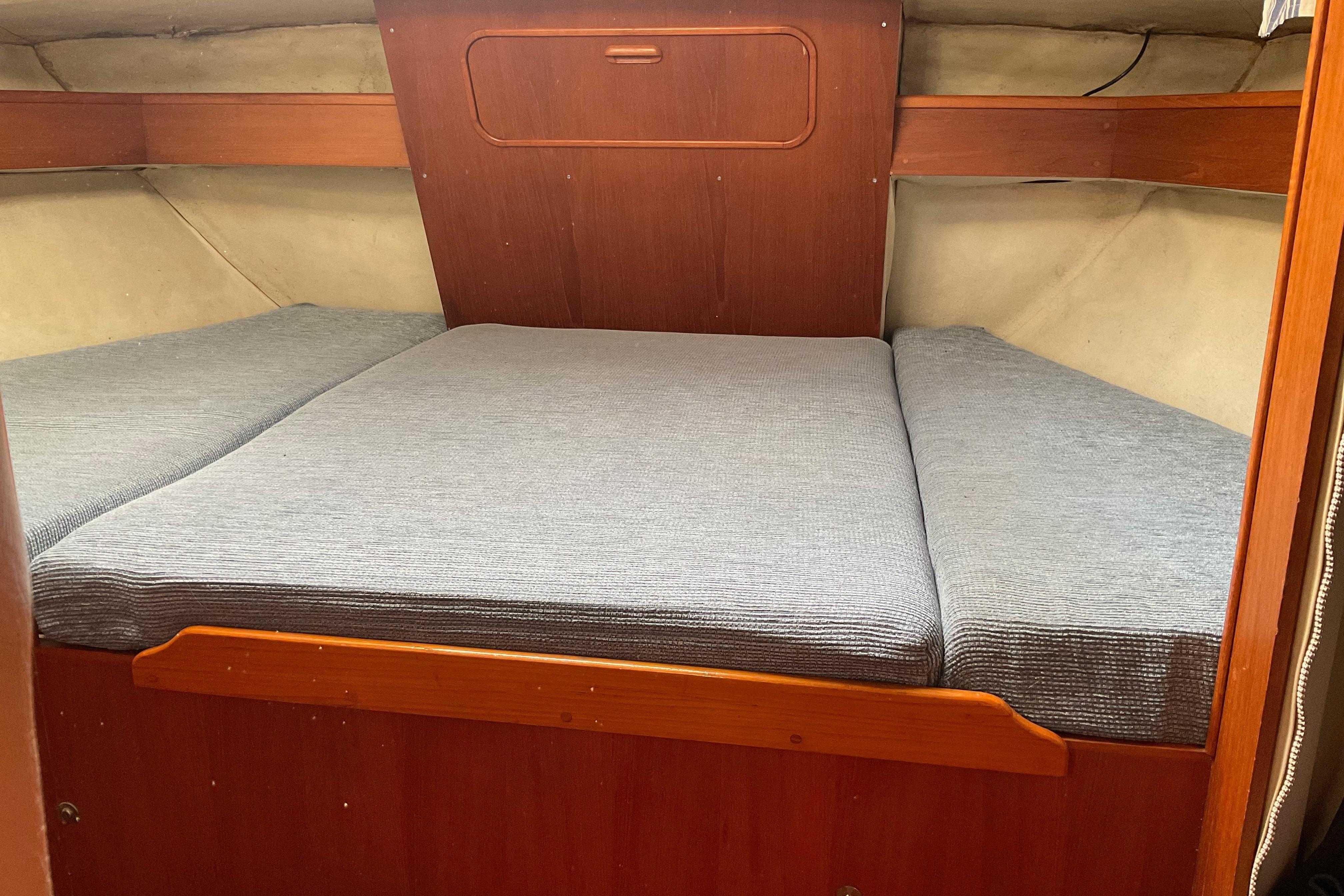 Interior cabin of 1988 Westerly Corsair 36 sailboat with cozy bedding.