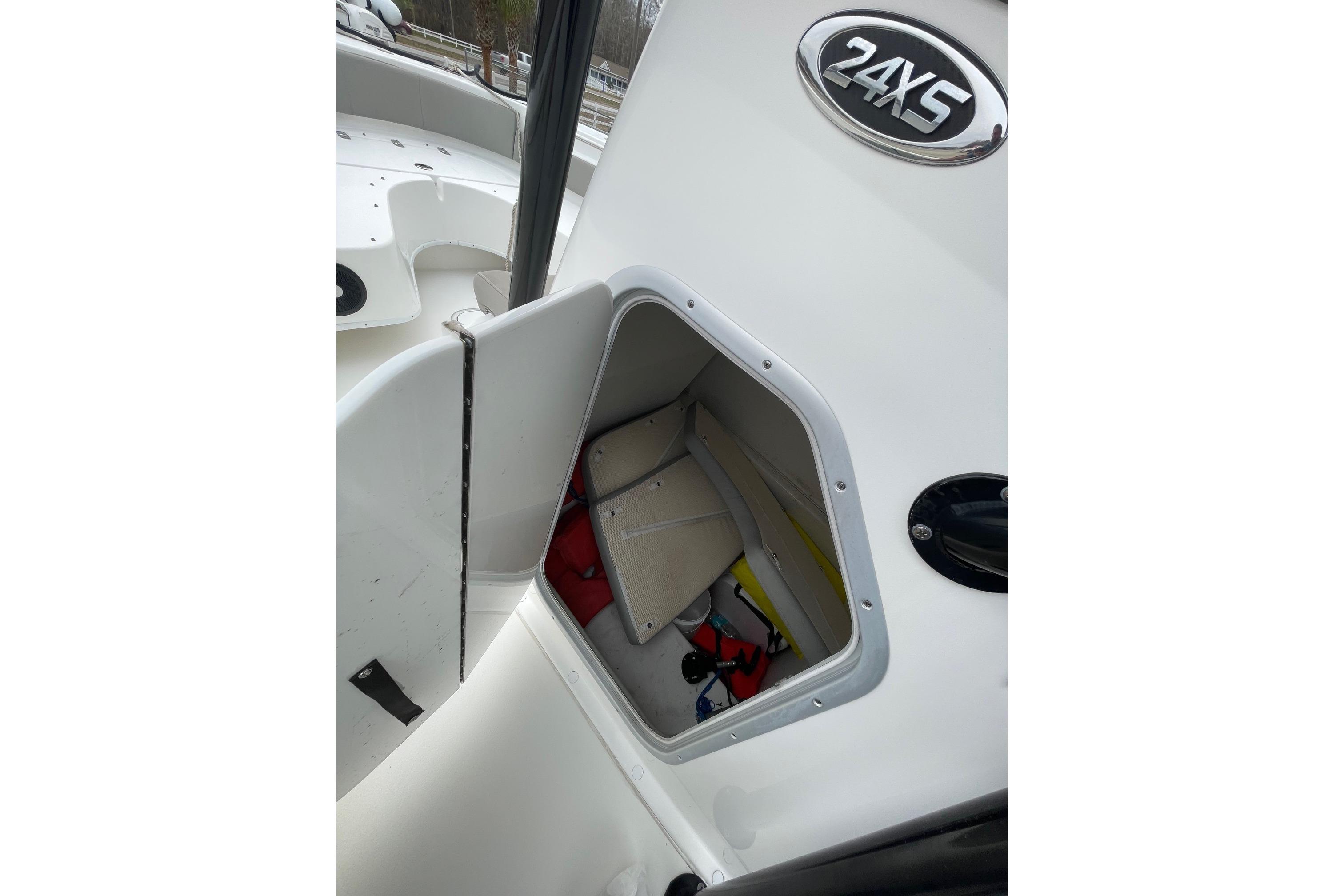 2023 Cape Horn 24 XS boat storage compartment with open hatch, showcasing interior space.