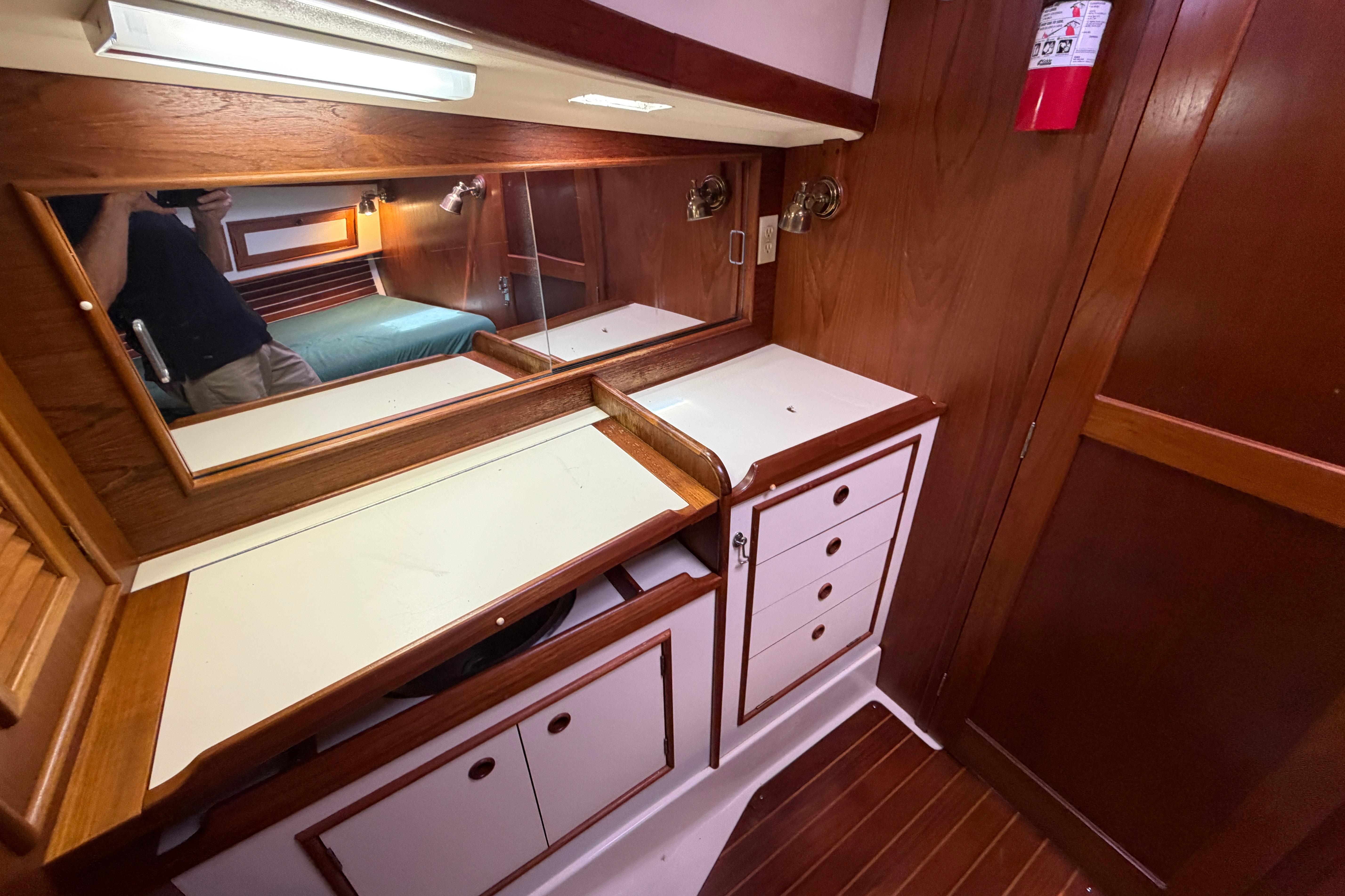 1989 Nonsuch 36 yacht interior with wooden cabinetry and mirror.