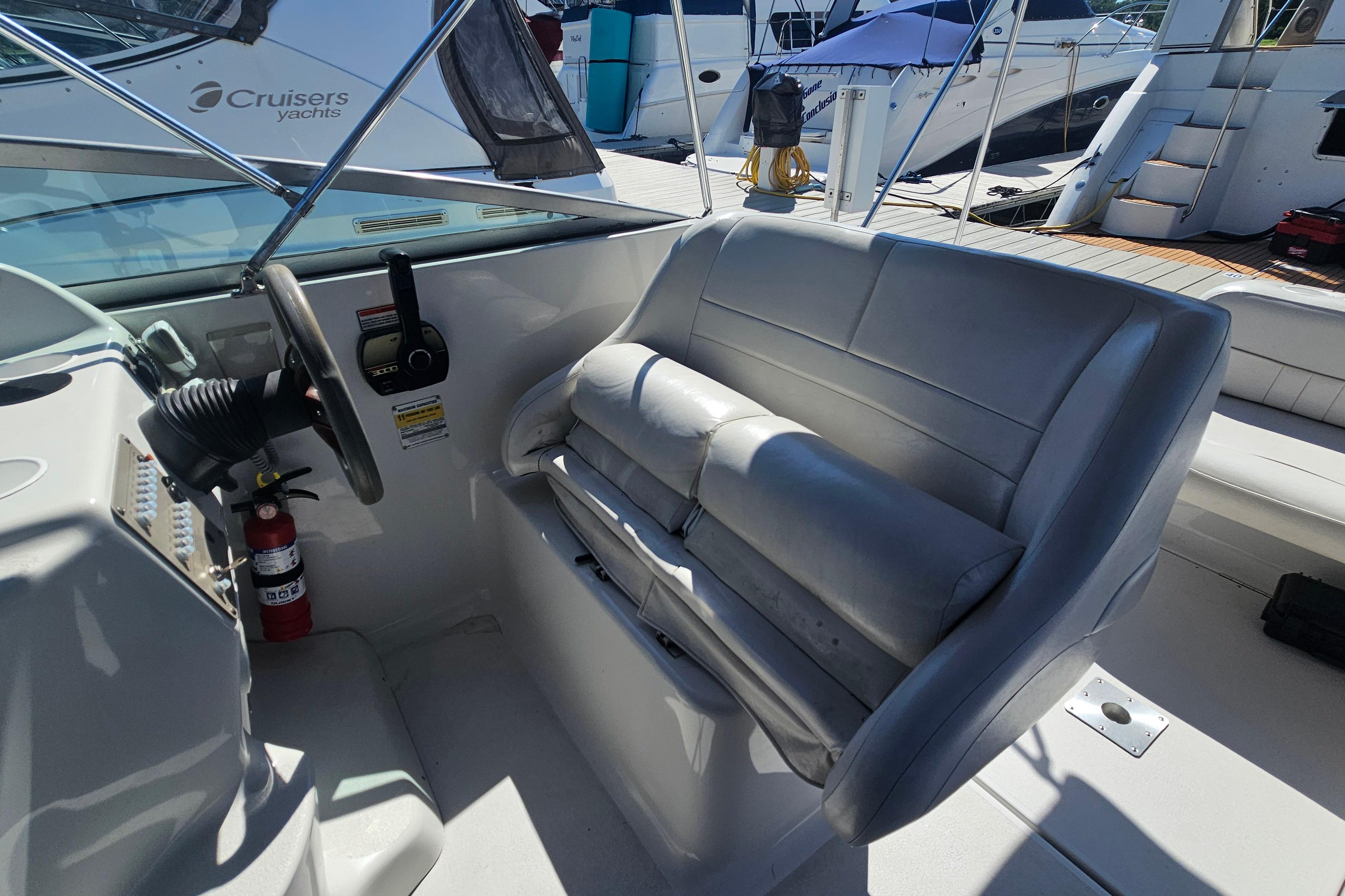 2000 Crownline 242 CR boat interior with steering wheel and cushioned seating.