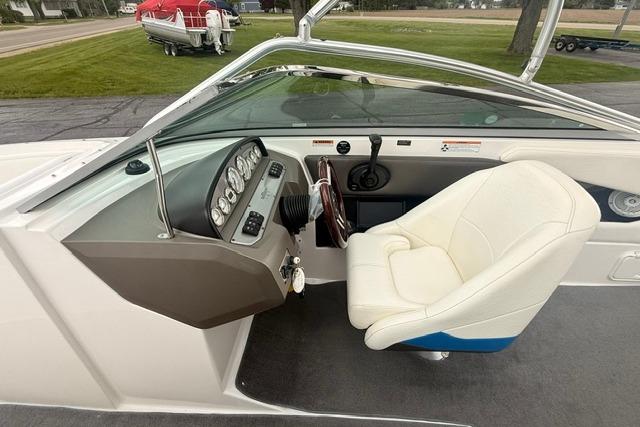 2007 Regal 2200 Bowrider boat interior with steering wheel and white captain's chair.