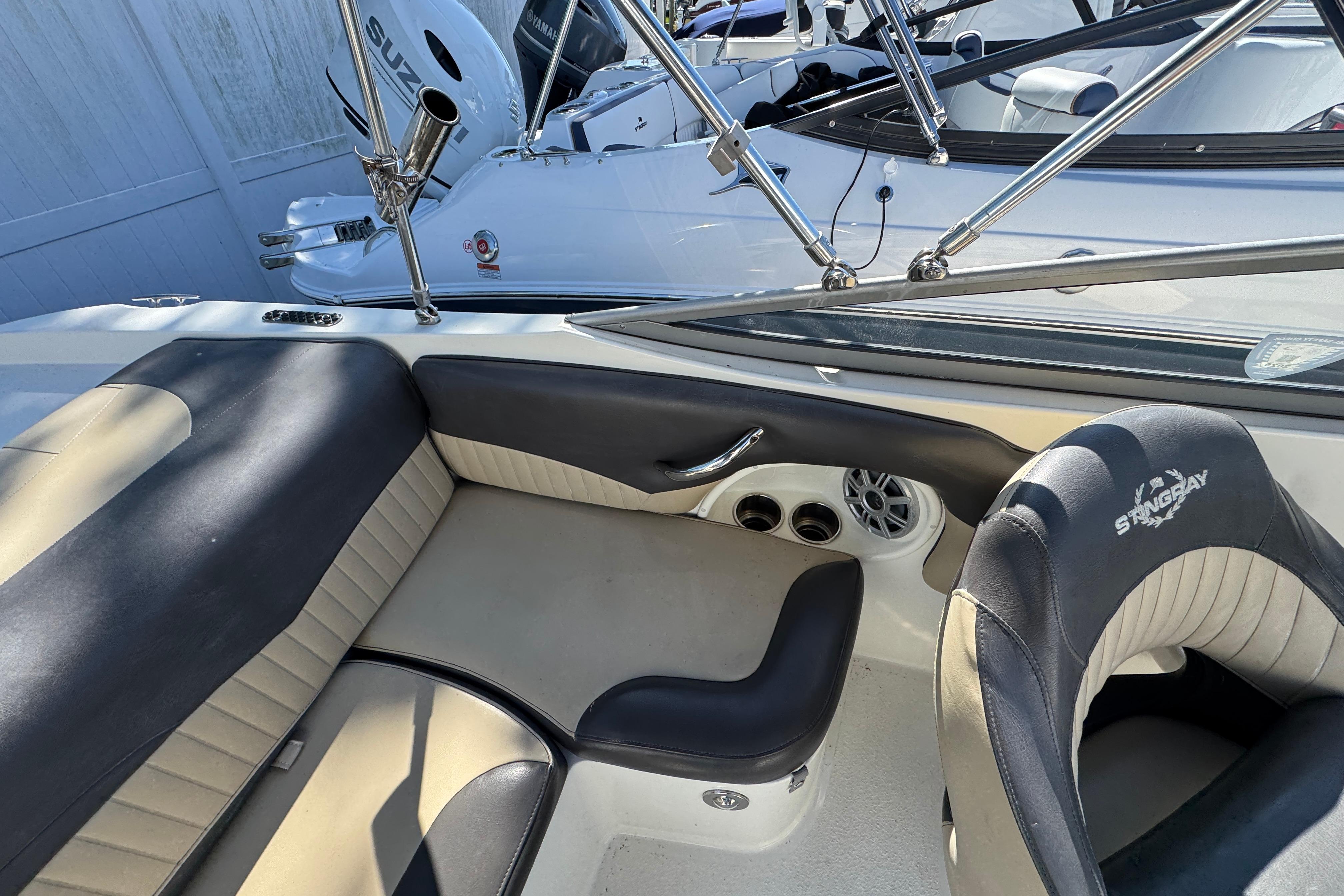 Interior of a 2018 Stingray 204 LR boat with beige and black seating.