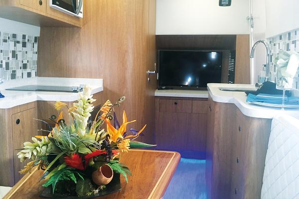 Interior of 2019 Altima 38 Xcape with modern kitchen and floral centerpiece.
