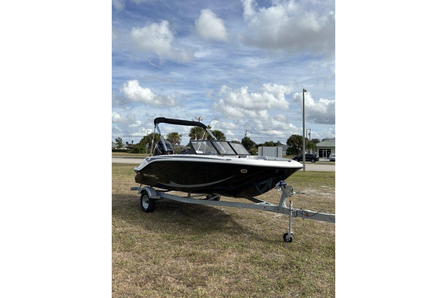 2025 Bayliner Element M17 boat on trailer under cloudy sky.