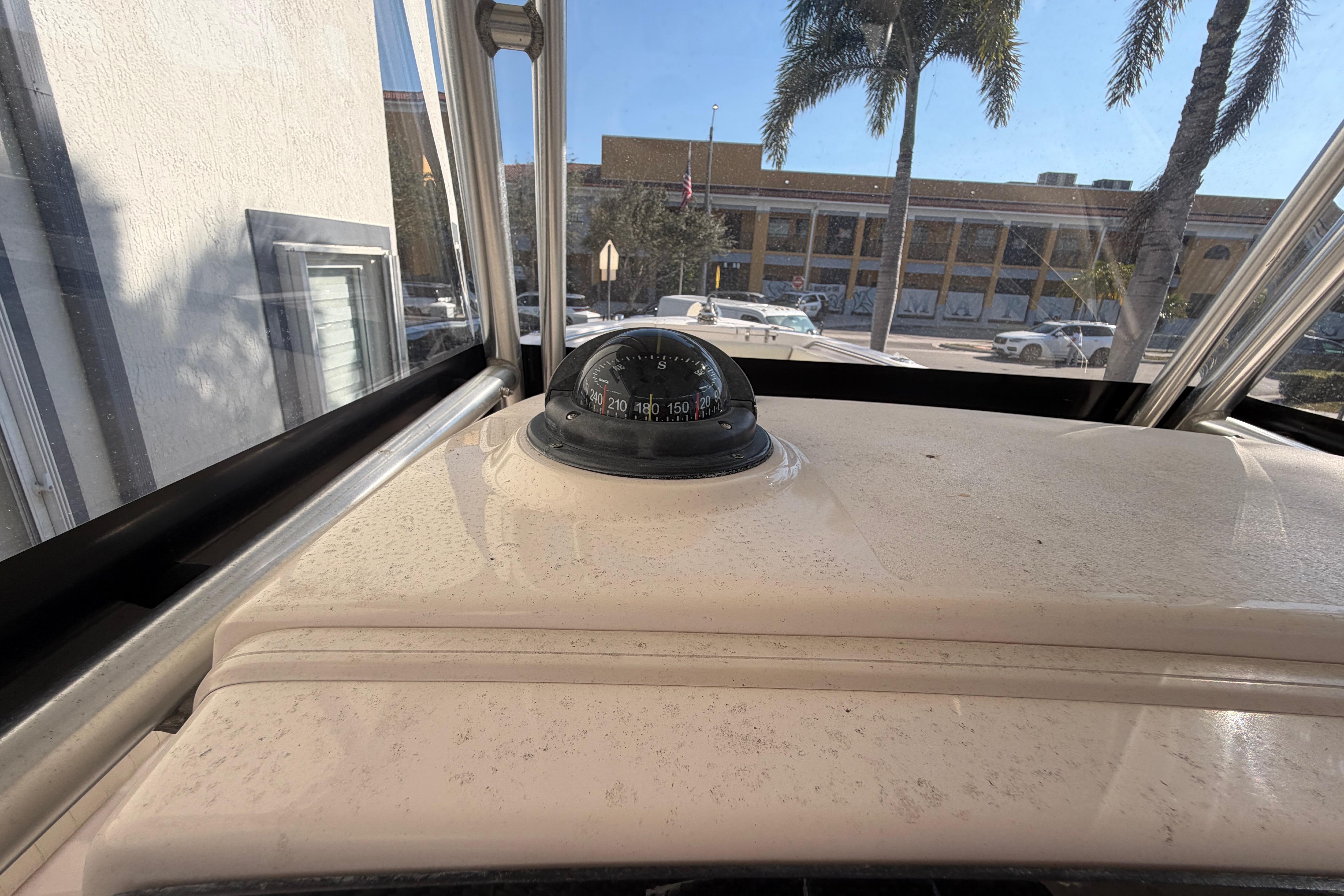 2004 Grady White 273 boat dashboard with compass, city street view.