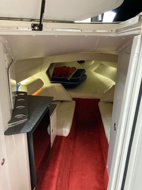 Interior of a 2001 Fountain Lightning yacht with red carpet.