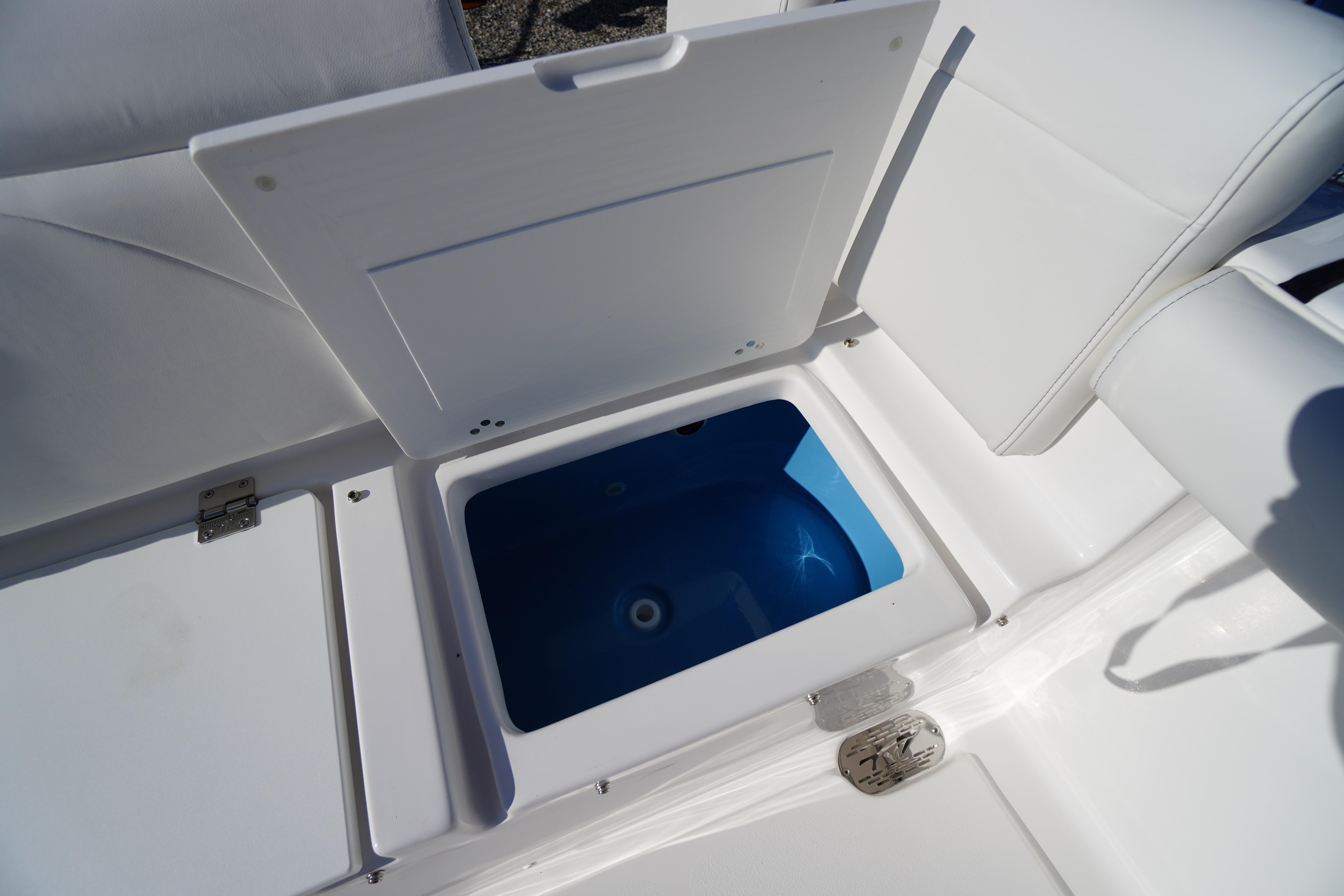 2026 Tidewater 272 LXF boat storage compartment with open lid, showcasing interior space.