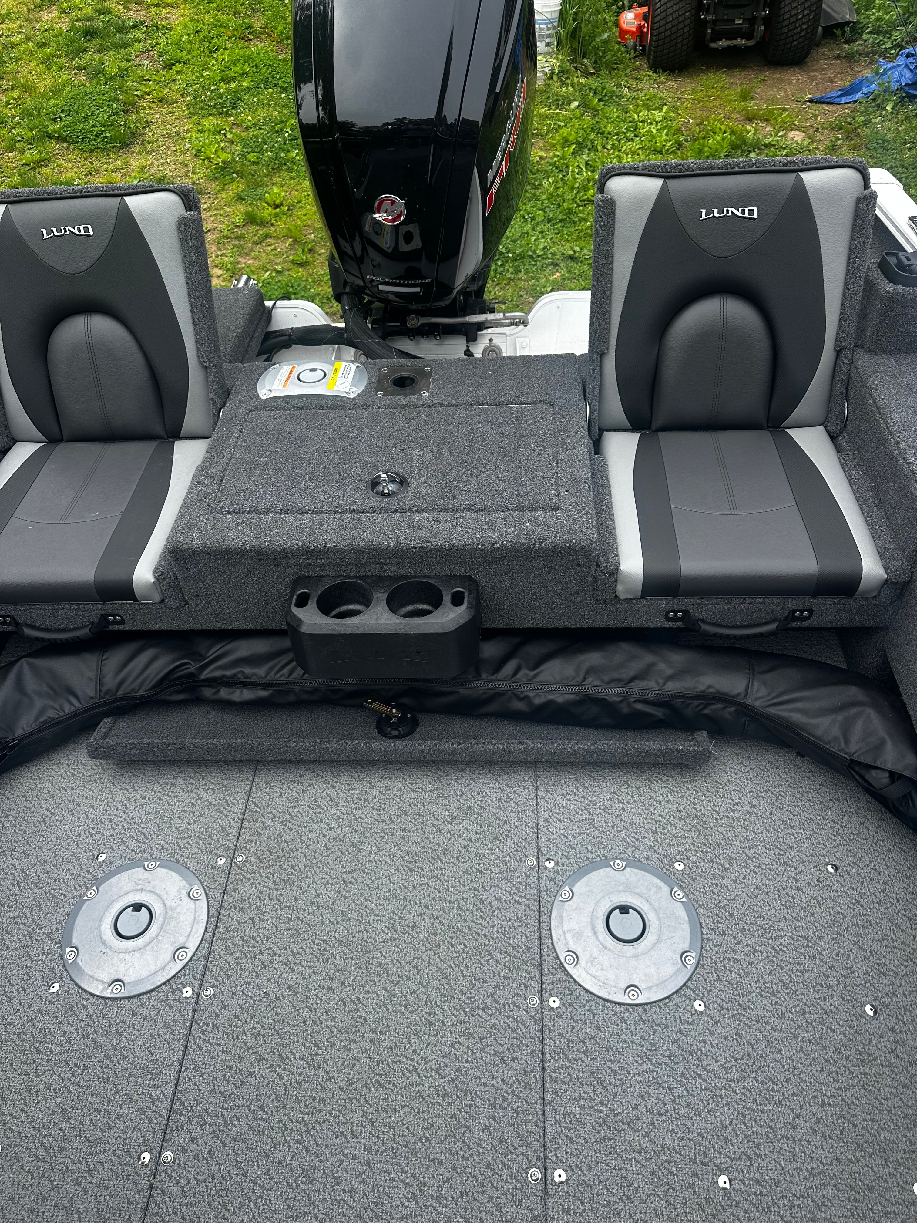 Interior of 2025 Lund 1775 Adventure SS with seating and motor.