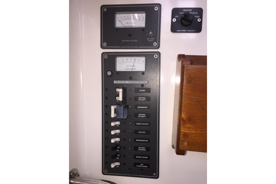 Electrical control panel on a 2007 Ranger Tugs R-25 SC boat, featuring various switches and meters.