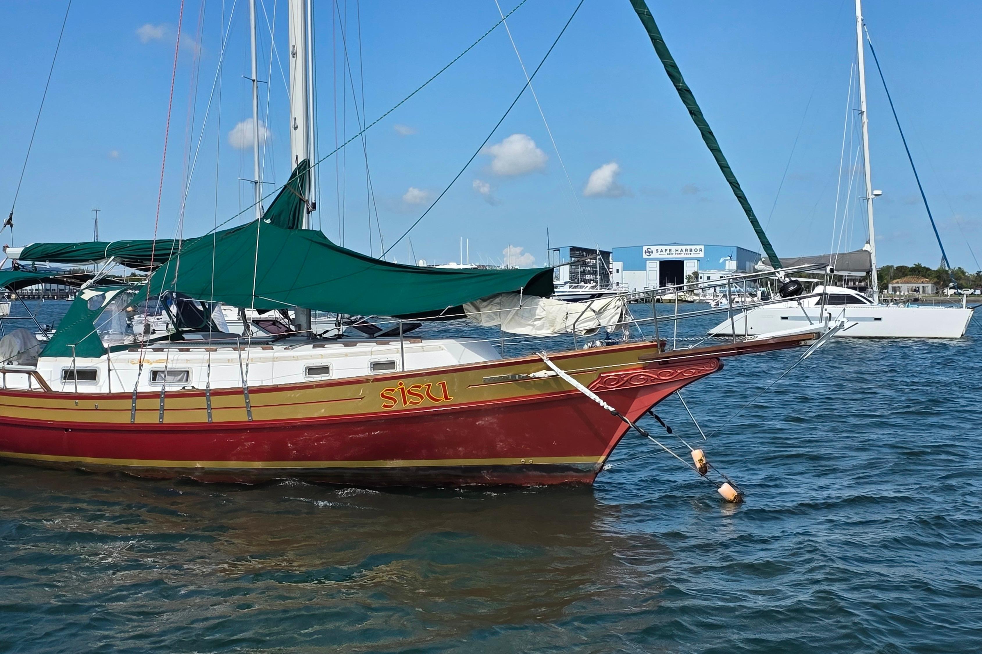 1987 Gozzard 36 Cruiser sailboat named "Sisu" docked in a marina.