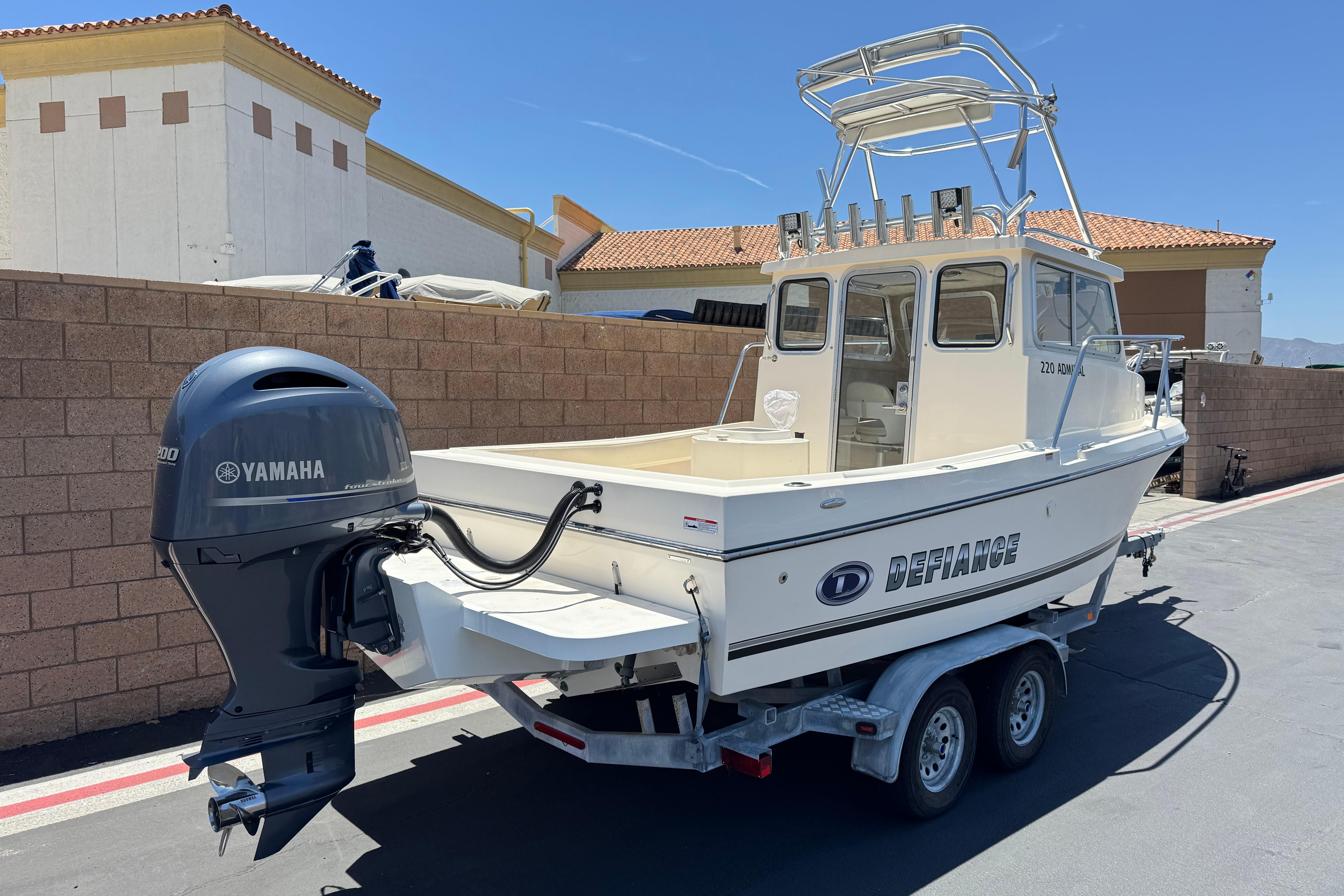 2017 Defiance Admiral 220 EX boat with Yamaha engine on trailer, parked outdoors.