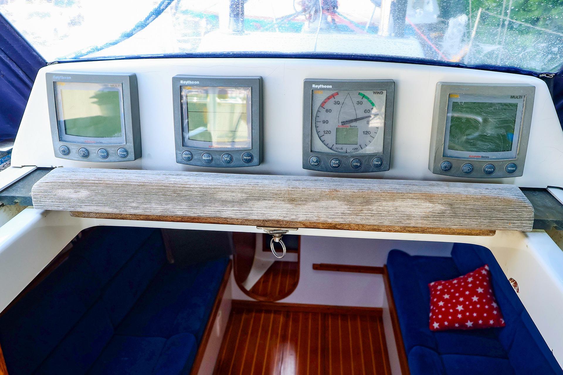 2001 J Boats J/32 cockpit with Raytheon navigation instruments and cozy interior seating.