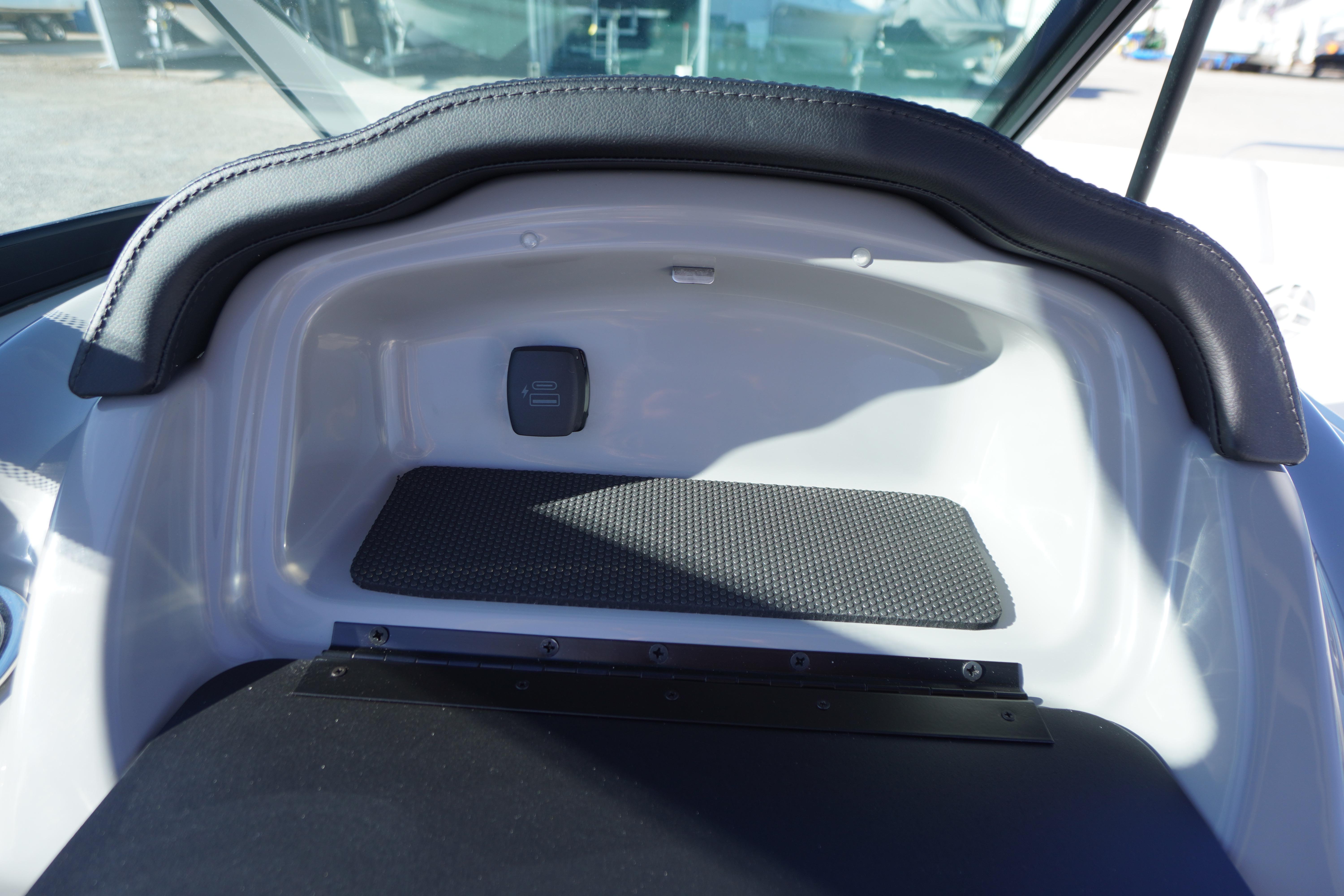 Interior view of 2026 Chaparral 23 SSi boat dashboard with storage compartment.