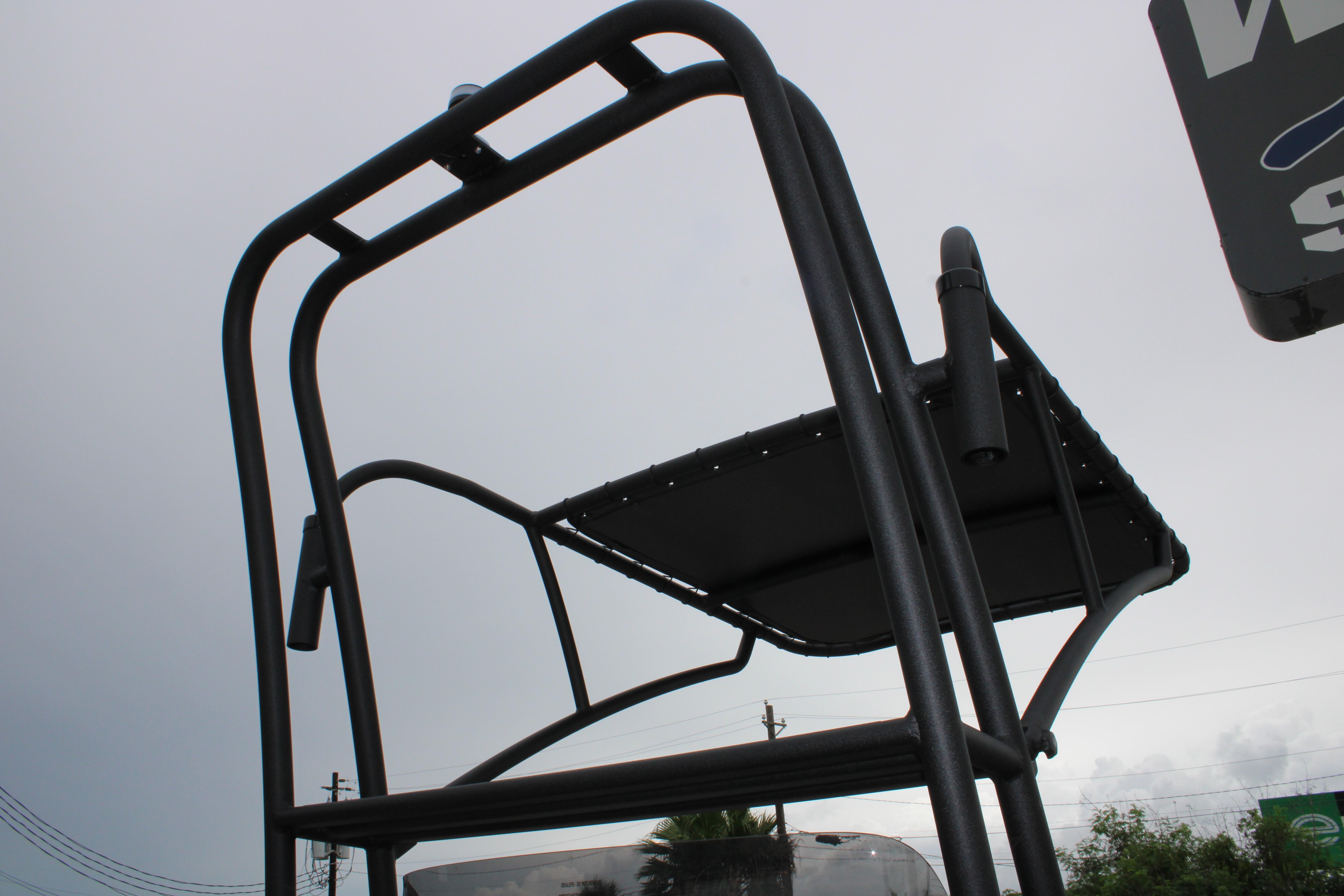 T-top structure of 2026 Freedom Boats 24 Defender against cloudy sky.