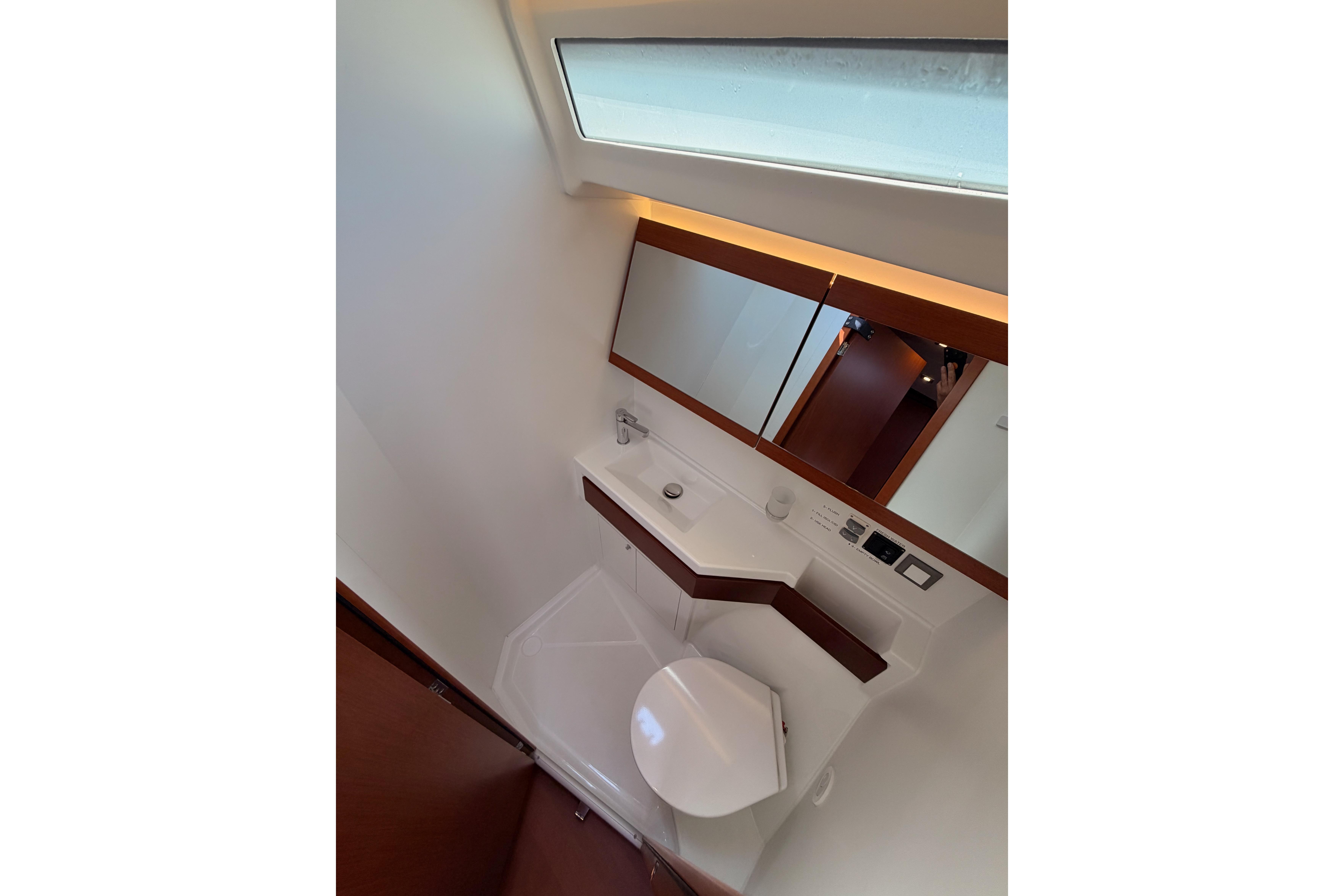 Bathroom interior of 2020 Beneteau Oceanis 46.1 yacht, featuring modern fixtures and mirror.