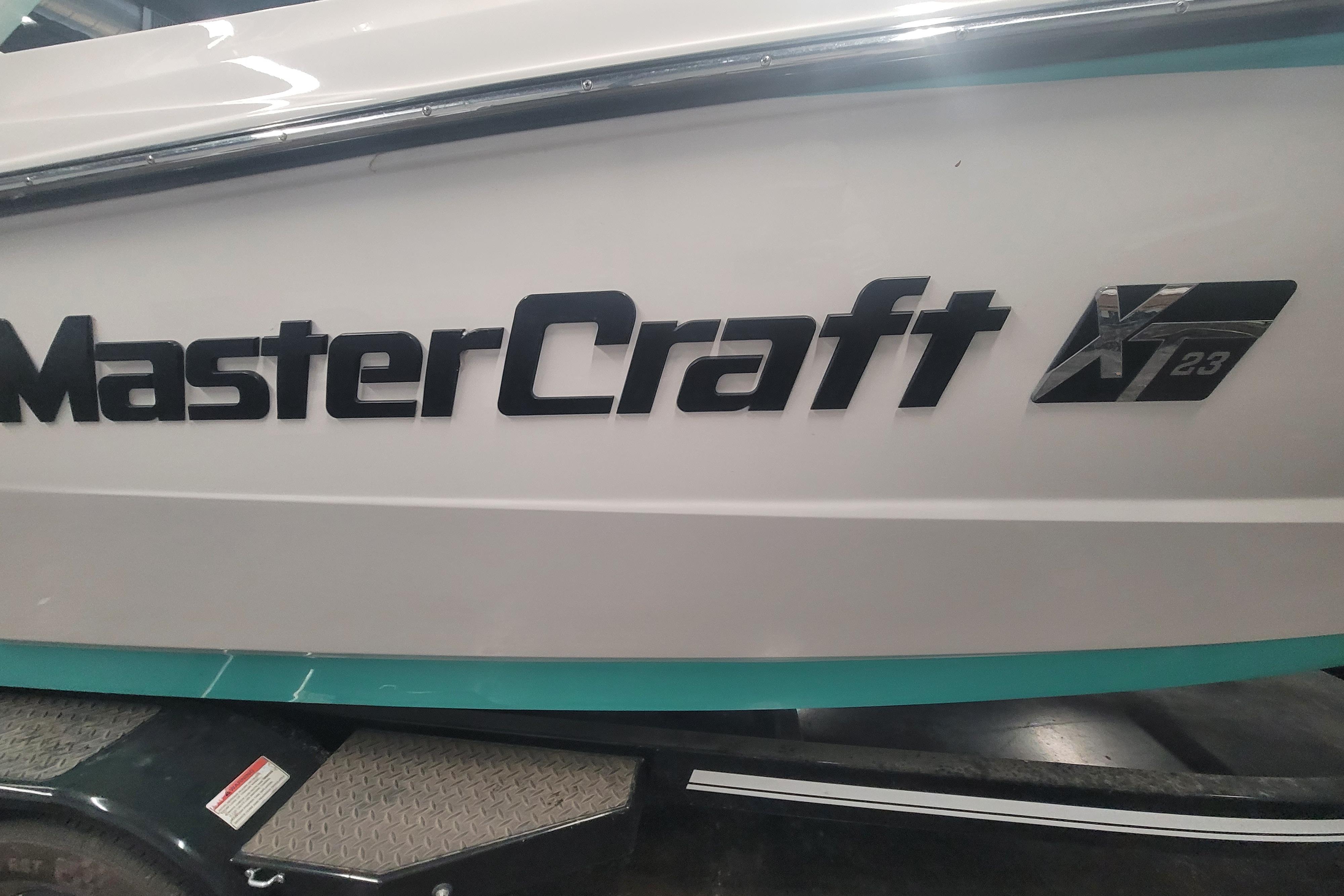 2020 MasterCraft XT23 boat side view with logo and model name.