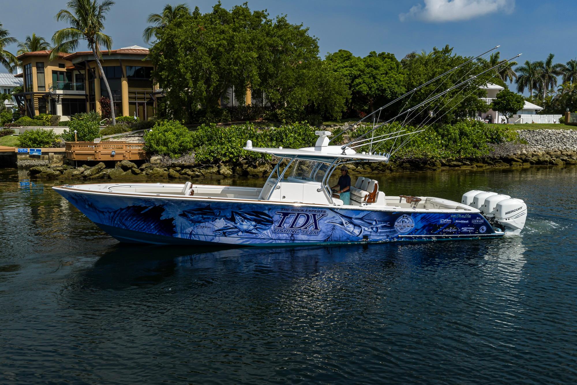 2020 Valhalla Boatworks V-41 with custom graphics, cruising near waterfront homes.